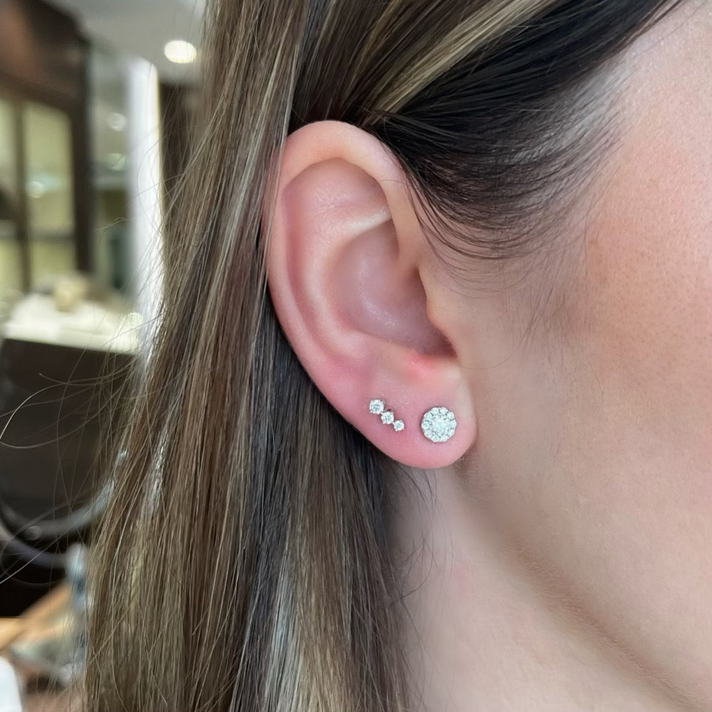 Female Model Wearing 0.64 ct Diamond Halo Stud Earrings - 18K gold weighing 1.09 grams - 22 round diamonds weighing 0.64 carats