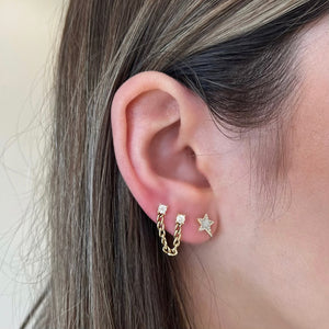 Female Model Wearing Mother of Pearl & Diamond Star Stud Earring - 14K gold weighing 1.36 grams  - 46 round diamonds weighing 0.11 carats  - 2 mother-of-pearl slices weighing 0.13 carats