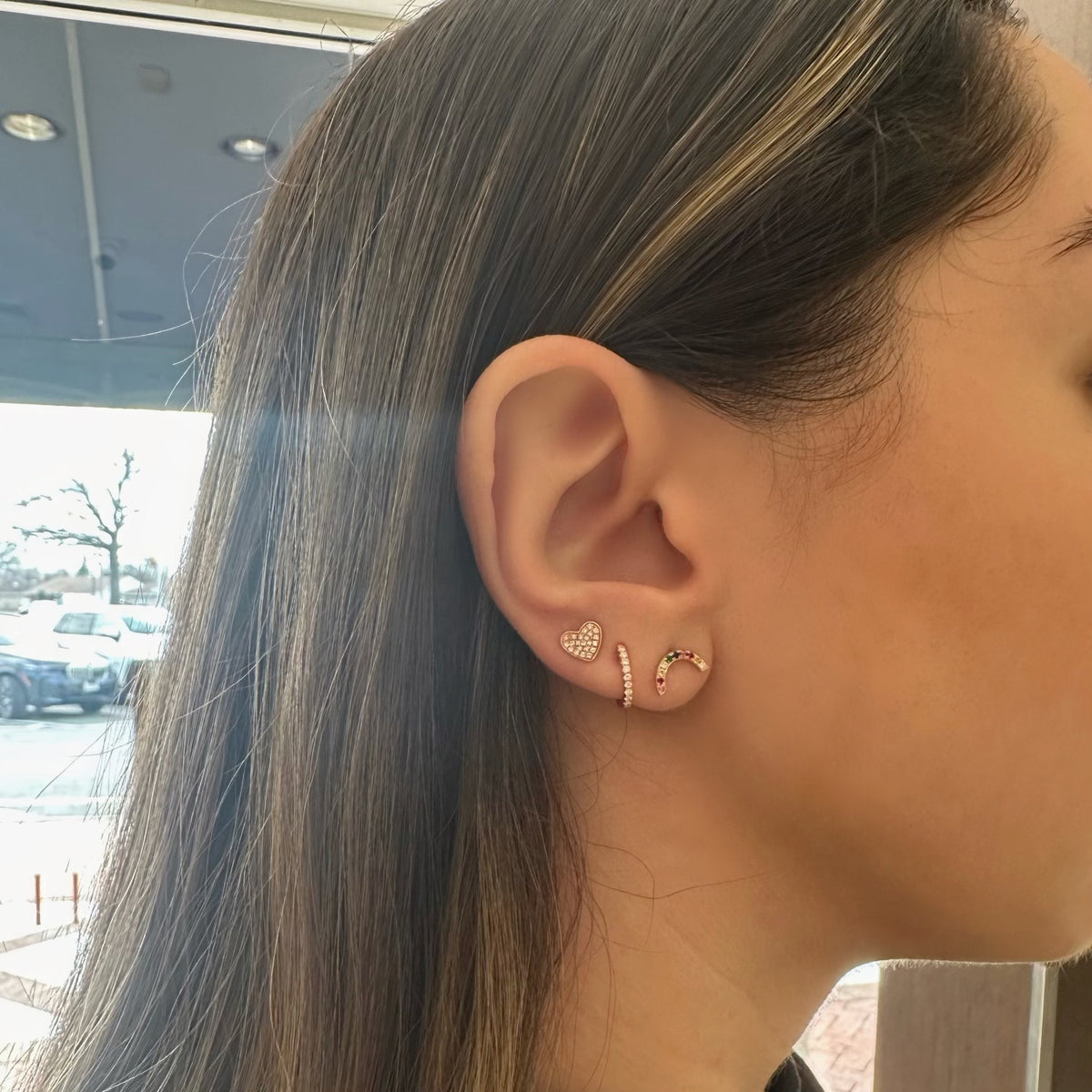 Female Model Wearing Pave Diamond Chubby Heart Stud Earrings - 14K gold weighing 1.13 grams - 44 round diamonds weighing 0.12 carats