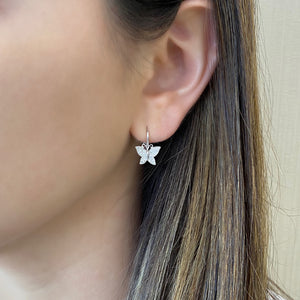 Female Model Wearing Diamond Butterfly Lever-Back Earrings - 14K gold weighing 1.91 grams  - 64 round diamonds weighing 0.20 carats