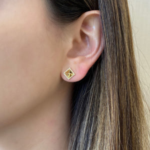 Female Model Wearing Diamond Pyramid Stud Earrings - 14K gold weighing 1.80 grams - 48 round diamonds weighing 0.12 carats