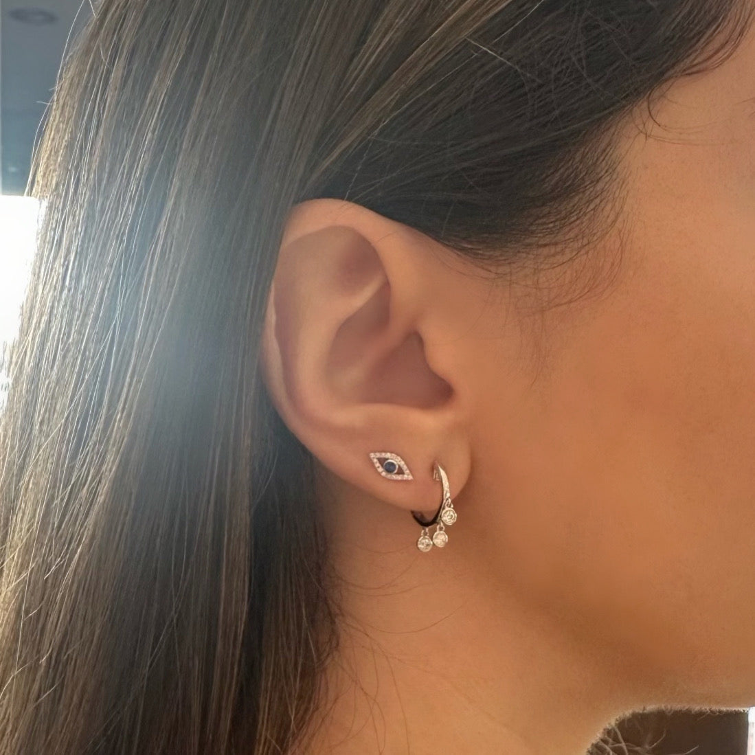 Female Model Wearing Bezel-Set Diamond Dangle Huggie Earrings - 18K gold weighing 3.46 grams - 6 round diamonds weighing 0.20 carats