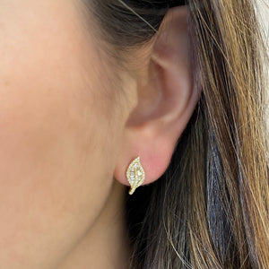 Female Model Wearing Baguette Diamond Leaf Stud Earrings - 14K gold weighing 1.98 grams  - 64 round diamonds weighing 0.15 carats   - 29 tapered baguettes weighing 0.27 carats 