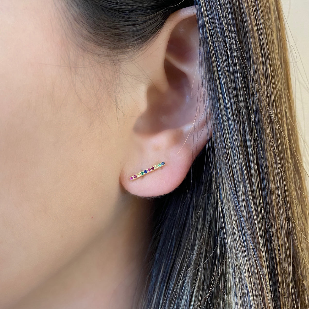 Female Model Wearing Rainbow Gemstone Bar Stud Earrings - 14K gold weighing 1.21 grams - 20 multicolor gemstones weighing 0.13 carats