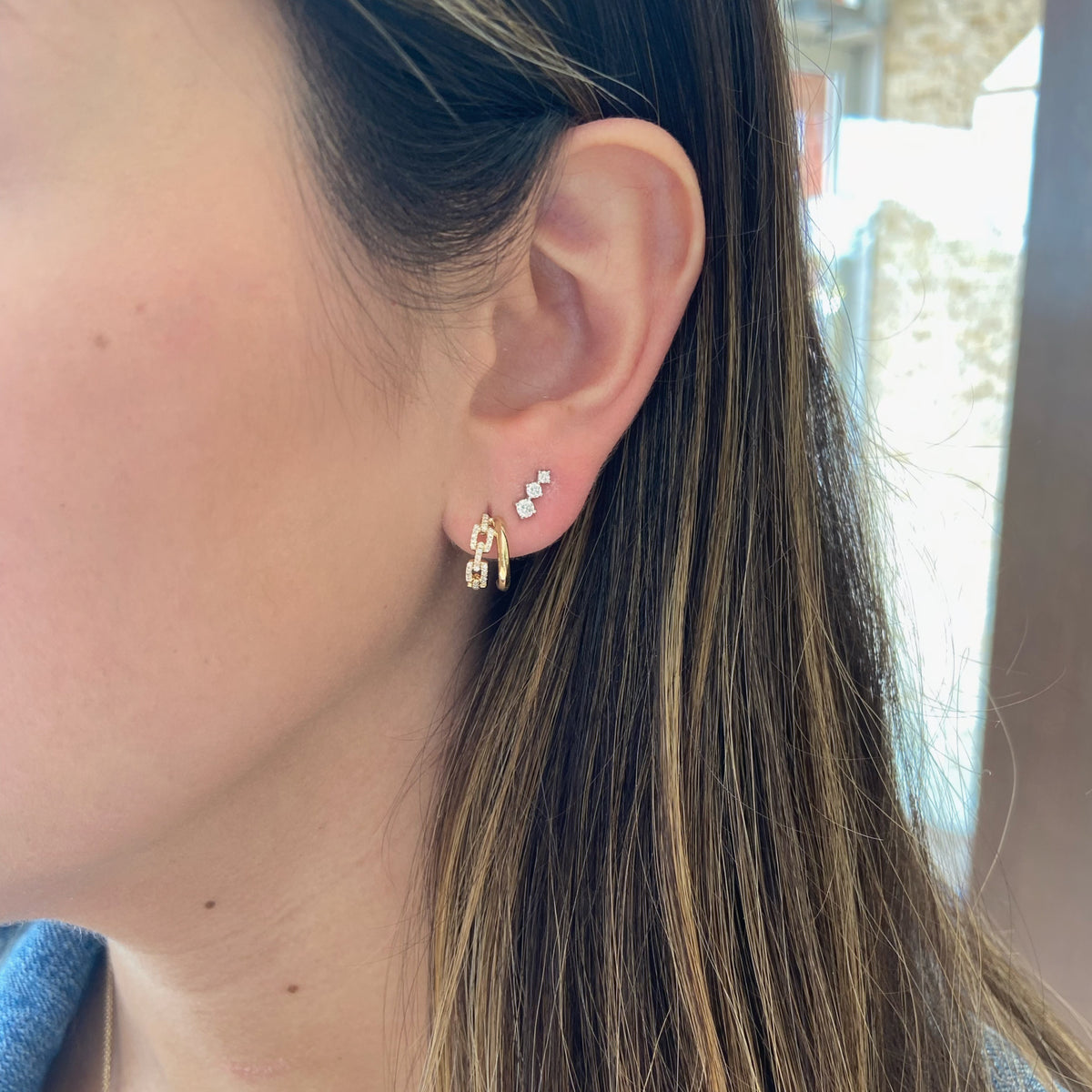 Female Model Wearing Graduated Diamond Trip Crawler Stud Earrings - 14K gold weighing 0.93 grams - 6 round diamonds weighing 0.28 carats