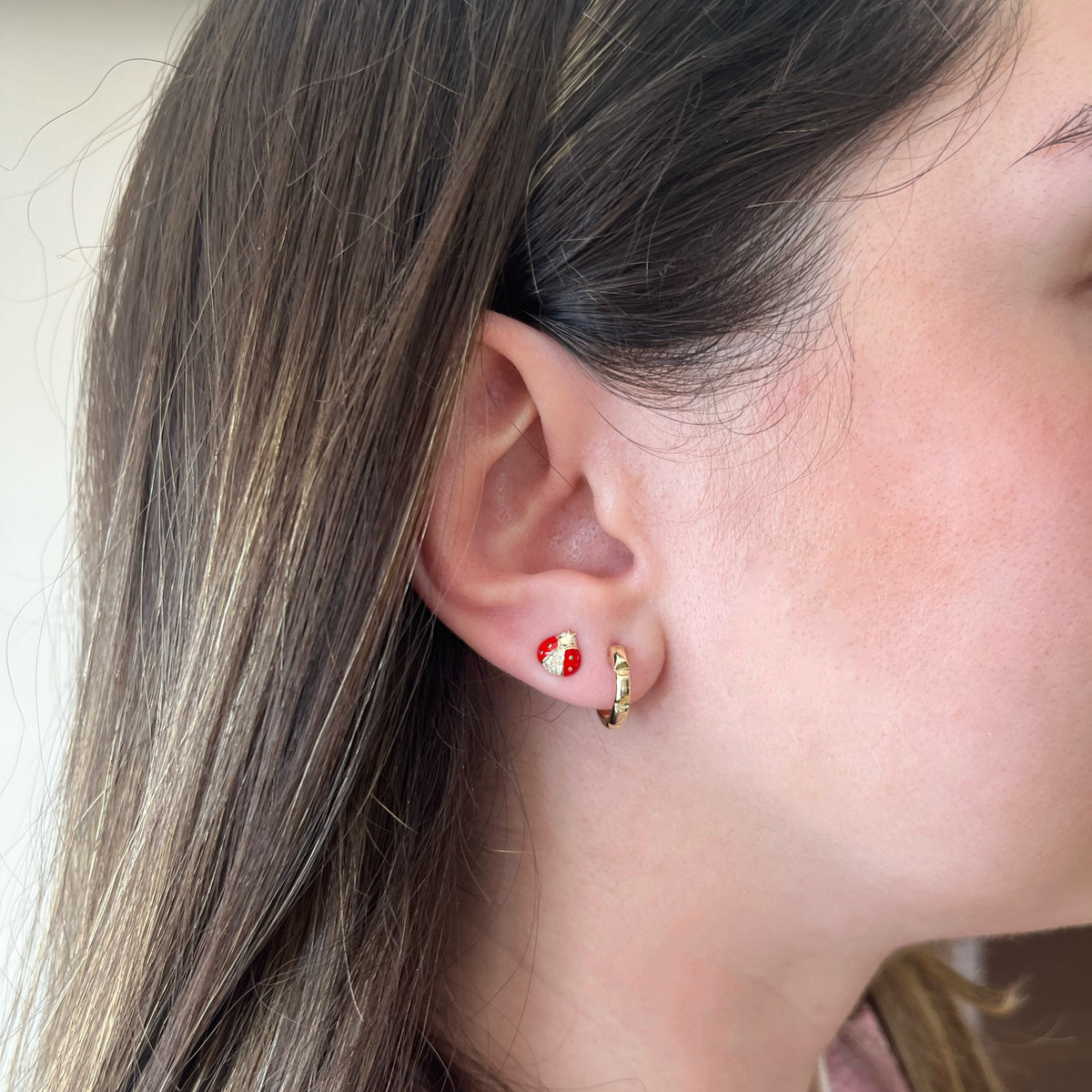 Female model wearing Textured gold huggie earrings - 14K gold weighing 2.32 grams