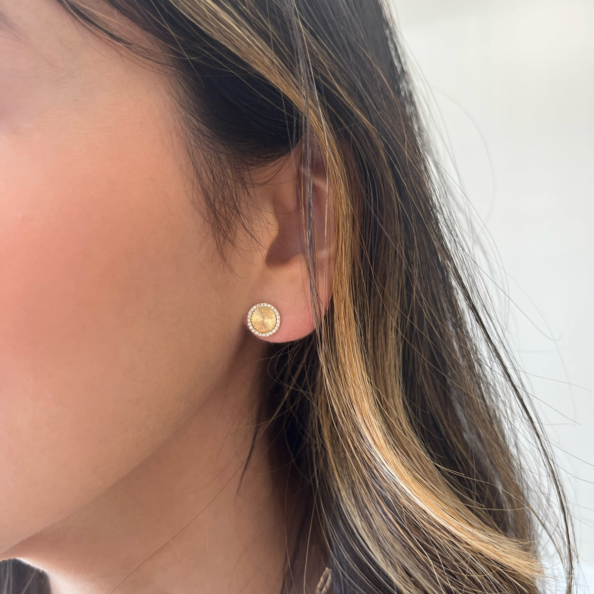 Female Model Wearing Diamond & Ridged Gold Button Stud Earrings - 14K gold weighing 1.86 grams - 50 round diamonds weighing 0.13 carats