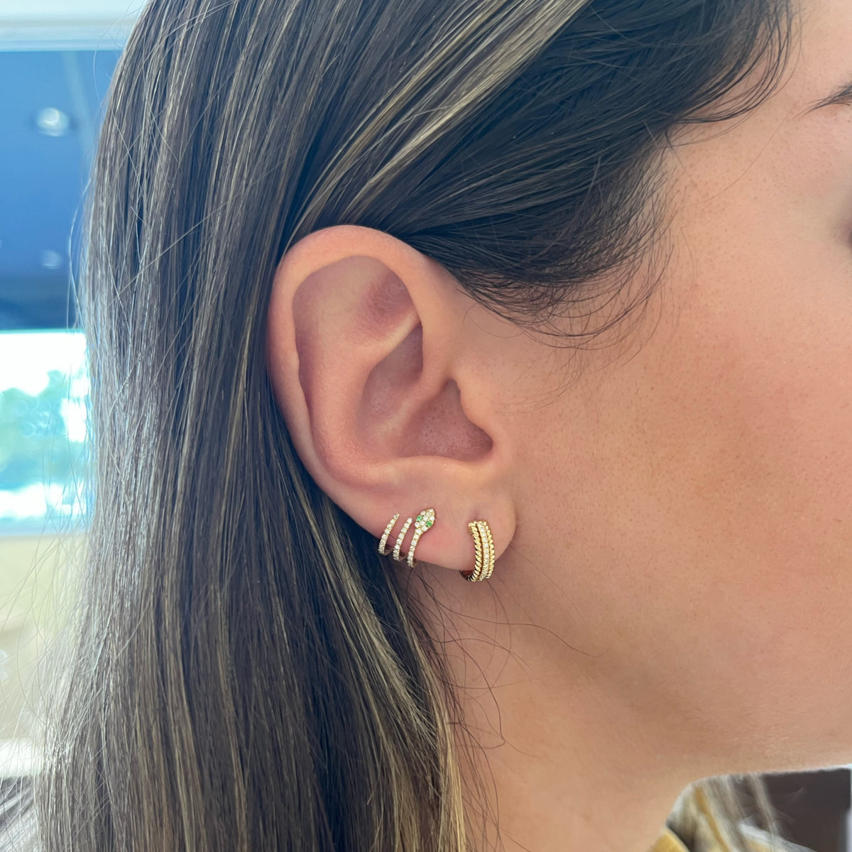 Female Model Wearing Diamond & Emerald Snake Crawler Earrings - 14K gold weighing 2.04 grams - 74 round diamonds weighing 0.27 carats - 4 emeralds weighing 0.03 carats