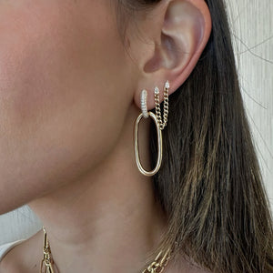 Female model wearing Diamond & Gold Oval Hoop Earrings - 14K gold weighing 11.98 grams - 74 round diamonds weighing 0.88 carats