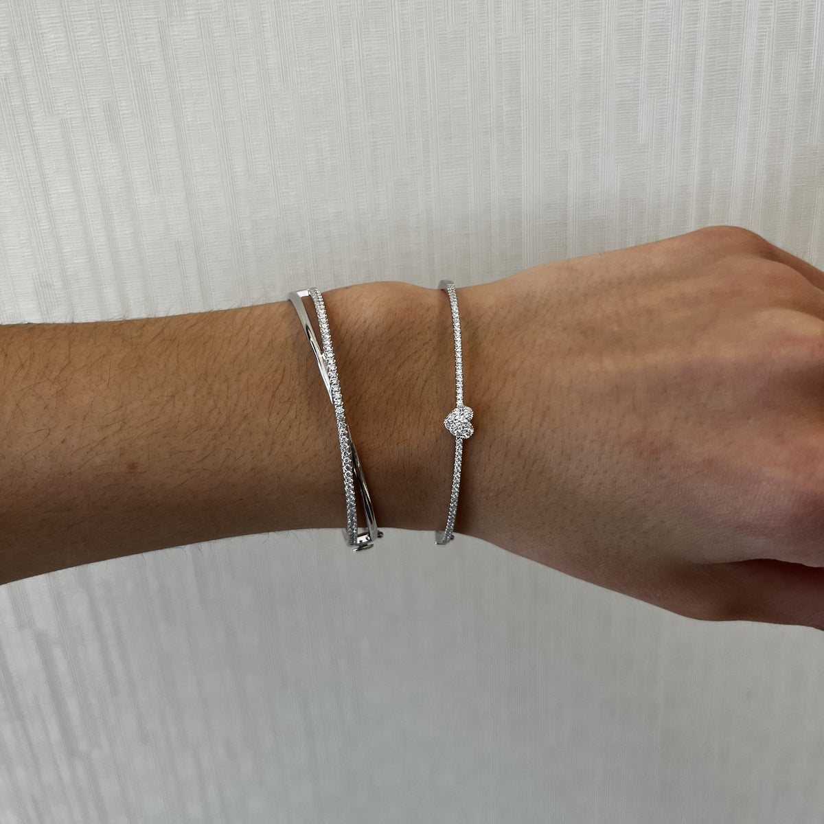 Female Model Wearing Diamond Heart Slim Bangle Bracelet - 18K gold weighing 8.29 grams - 62 round diamonds weighing 0.62 carats