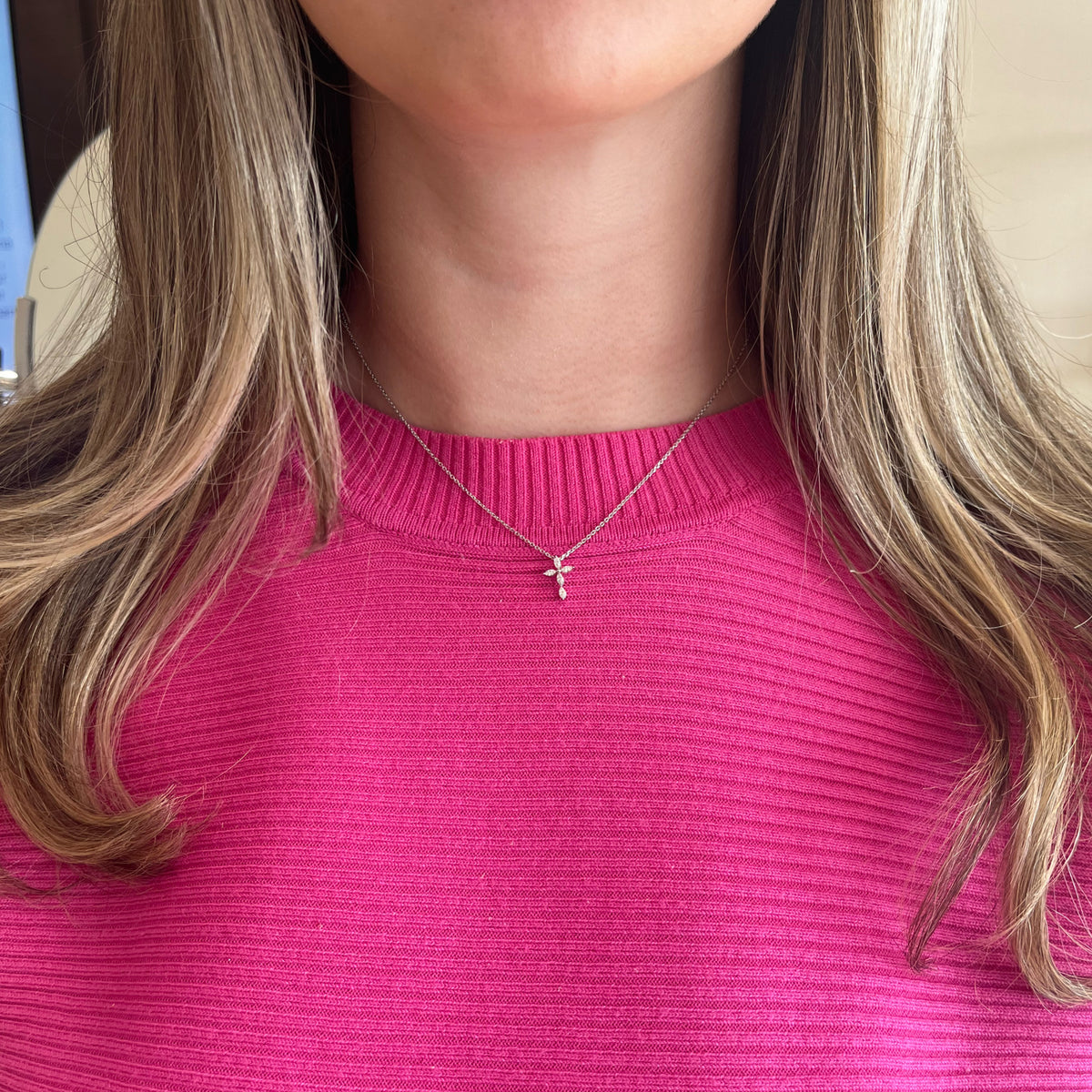 Female Model Wearing Marquise Diamond Cross Pendant Necklace - 18K gold weighing 0.33 grams (pendant) - 14K gold weighing 1.60 grams (necklace) - 5 marquise-shaped diamonds weighing 0.18 carats