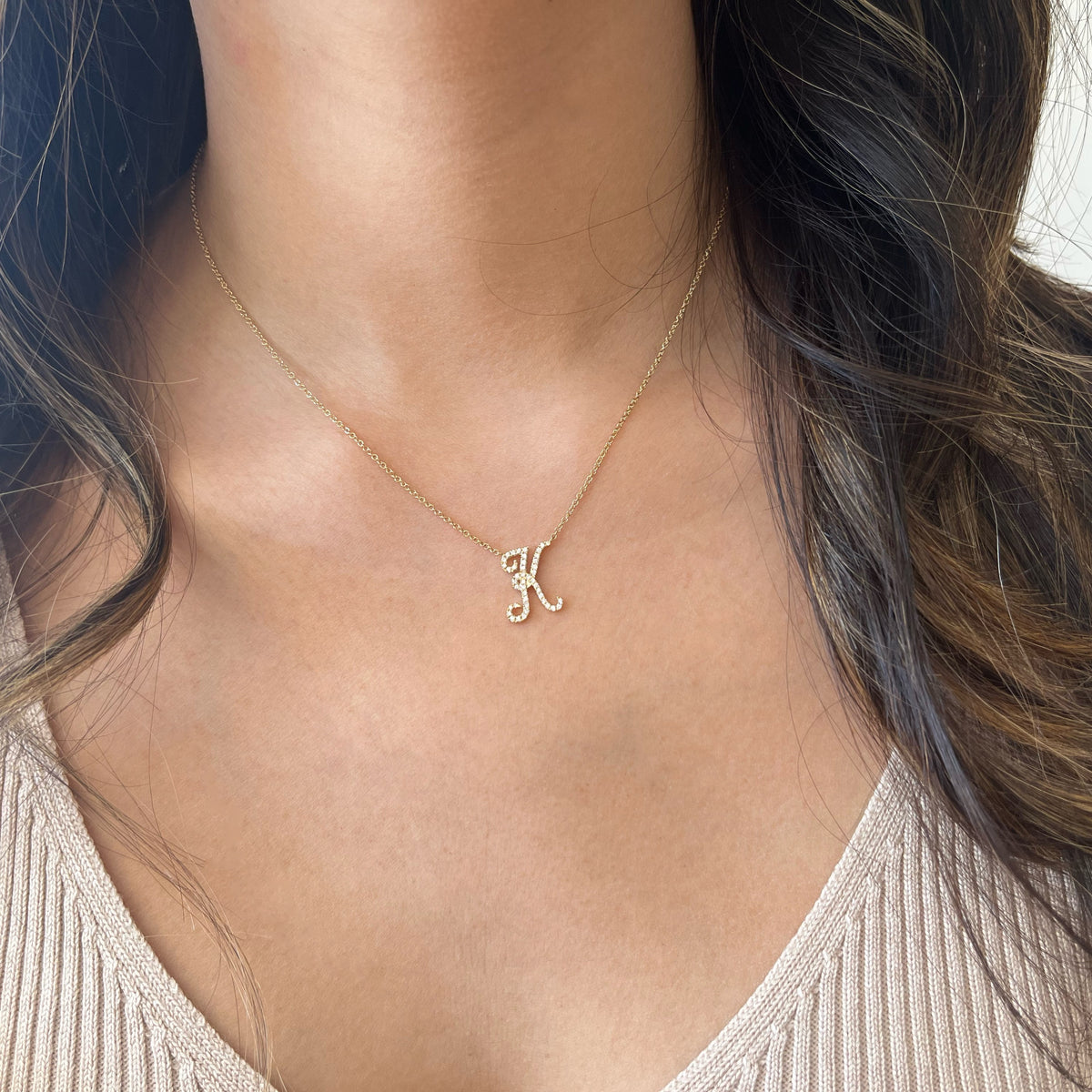 Female Model Wearing Diamond Script Initial Necklace - 14K gold weighing 2.50 grams  - 44 round diamonds weighing 0.21 carats