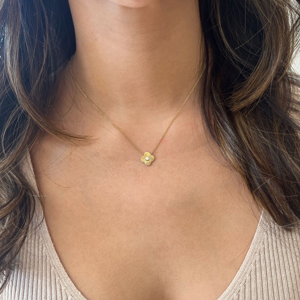 Female Model Wearing Diamond & Ridged Gold Clover Pendant Necklace - 14K gold weighing 2.22 grams  - 0.05 ct round diamond 