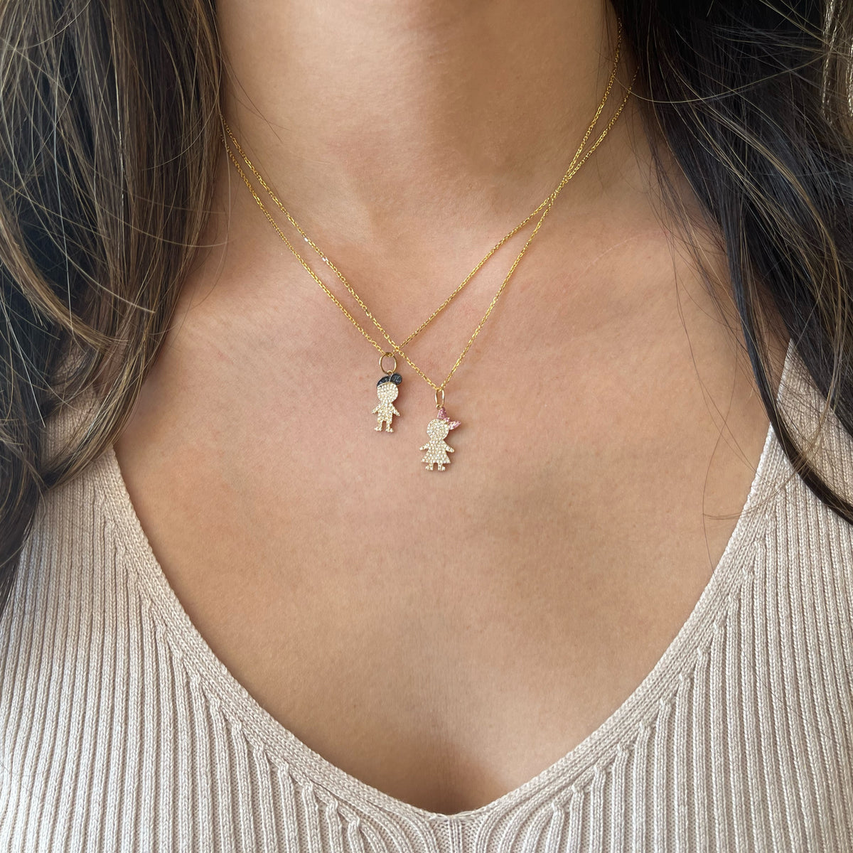 Female Model Wearing Diamond & Sapphire Boy Pendant - 14K gold weighing 2.50 grams  - 65 round diamonds weighing 0.13 carats  - 7 sapphires weighing 0.02 carats
