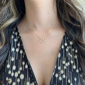Female Model Wearing Diamond Interlocking Circles Necklace - 18K gold weighing 2.86 grams - 37 round diamonds weighing 0.42 carats