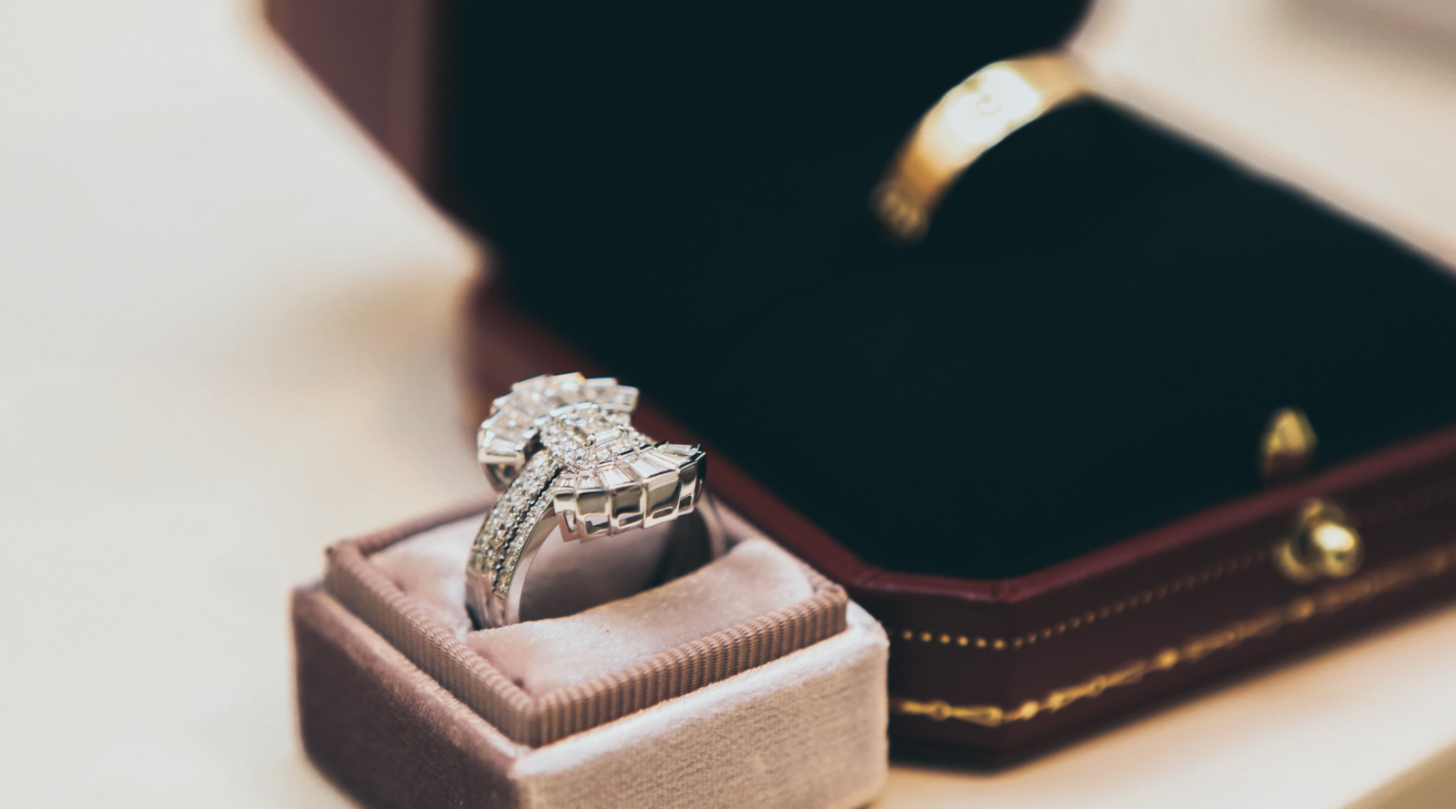 Diamond wedding bands in nuha jewelry boxes sitting on a table