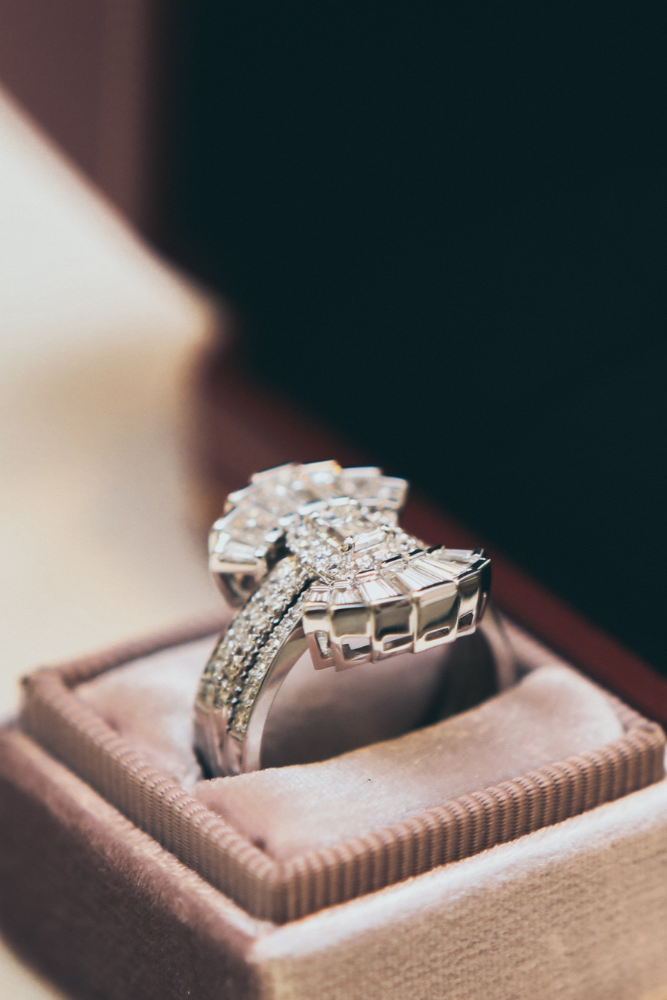 Diamond wedding band in nuha jewelry box sitting on a table