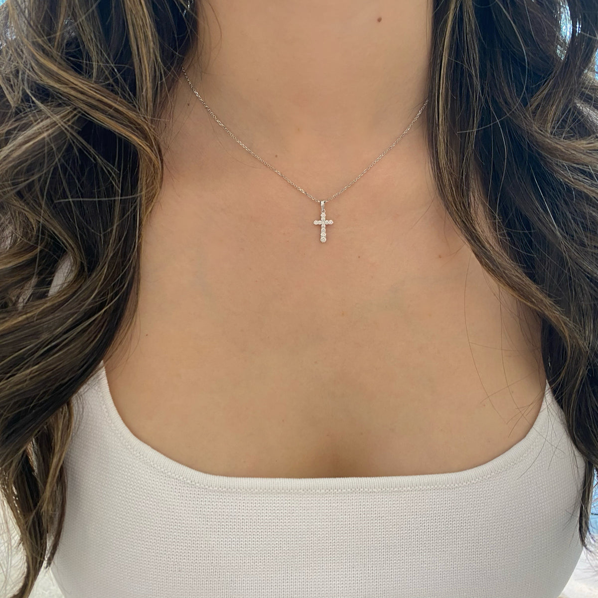 Female Model Wearing 0.23 ct Diamond Cross Pendant - 18K gold weighing 0.62 grams - 14K gold weighing 1.60 grams  - 11 round diamonds weighing 0.23 carats