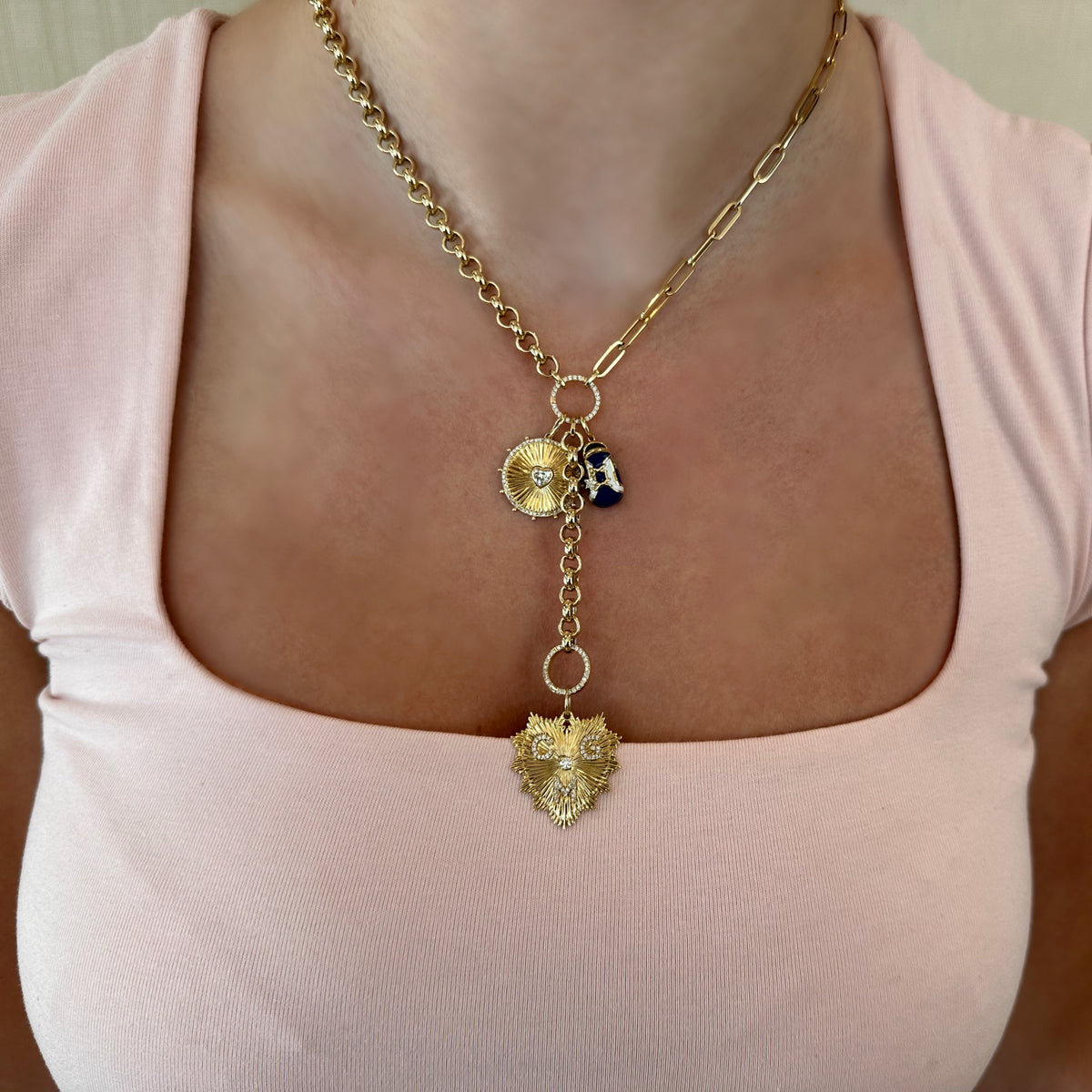 Female Model Wearing Fluted Gold Heart Pendant with Diamonds - 14K gold weighing 2.57 grams - 63 round diamonds weighing 0.33 carats