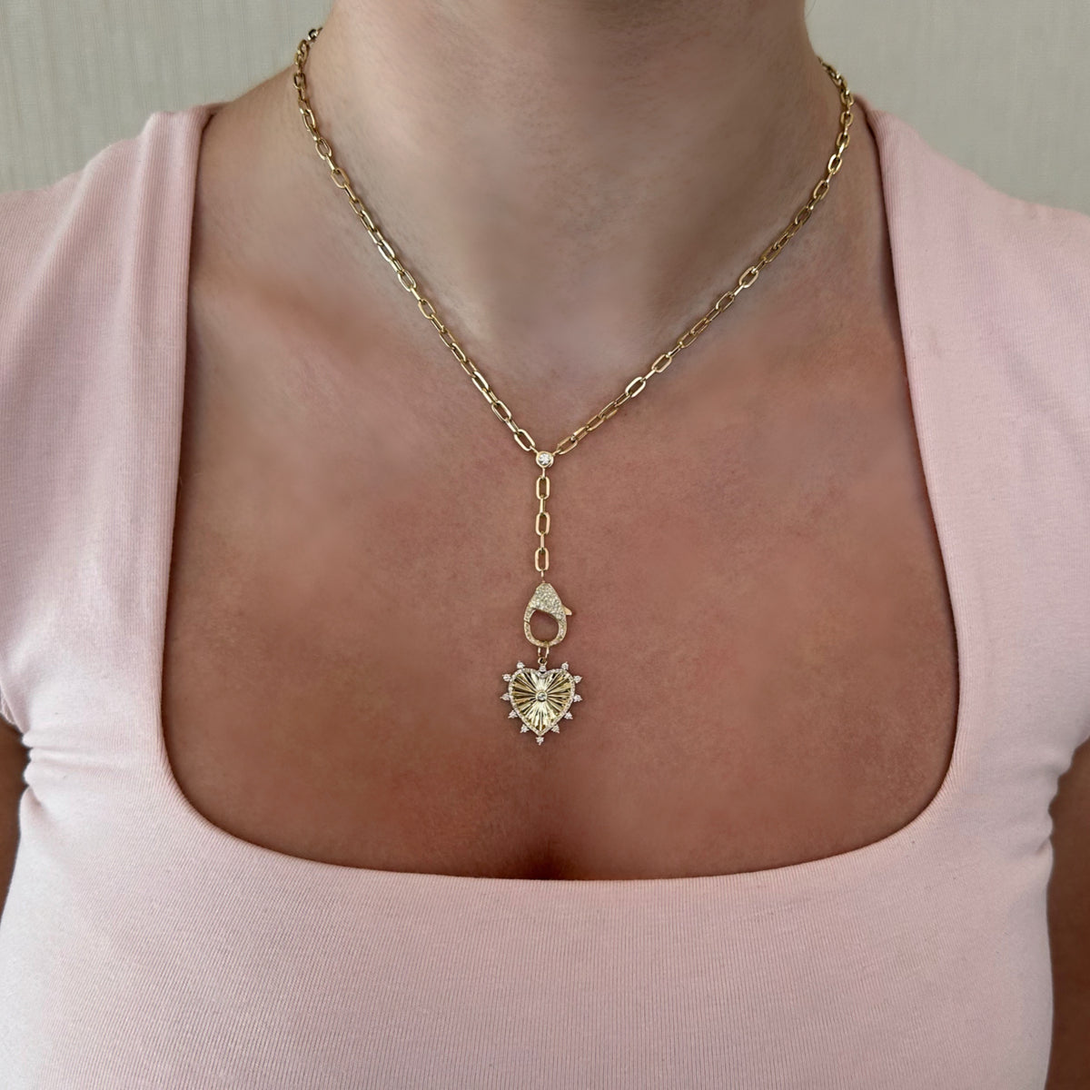 Female Model Wearing Fluted Gold Heart Pendant with Diamonds - 14K gold weighing 2.57 grams - 63 round diamonds weighing 0.33 carats