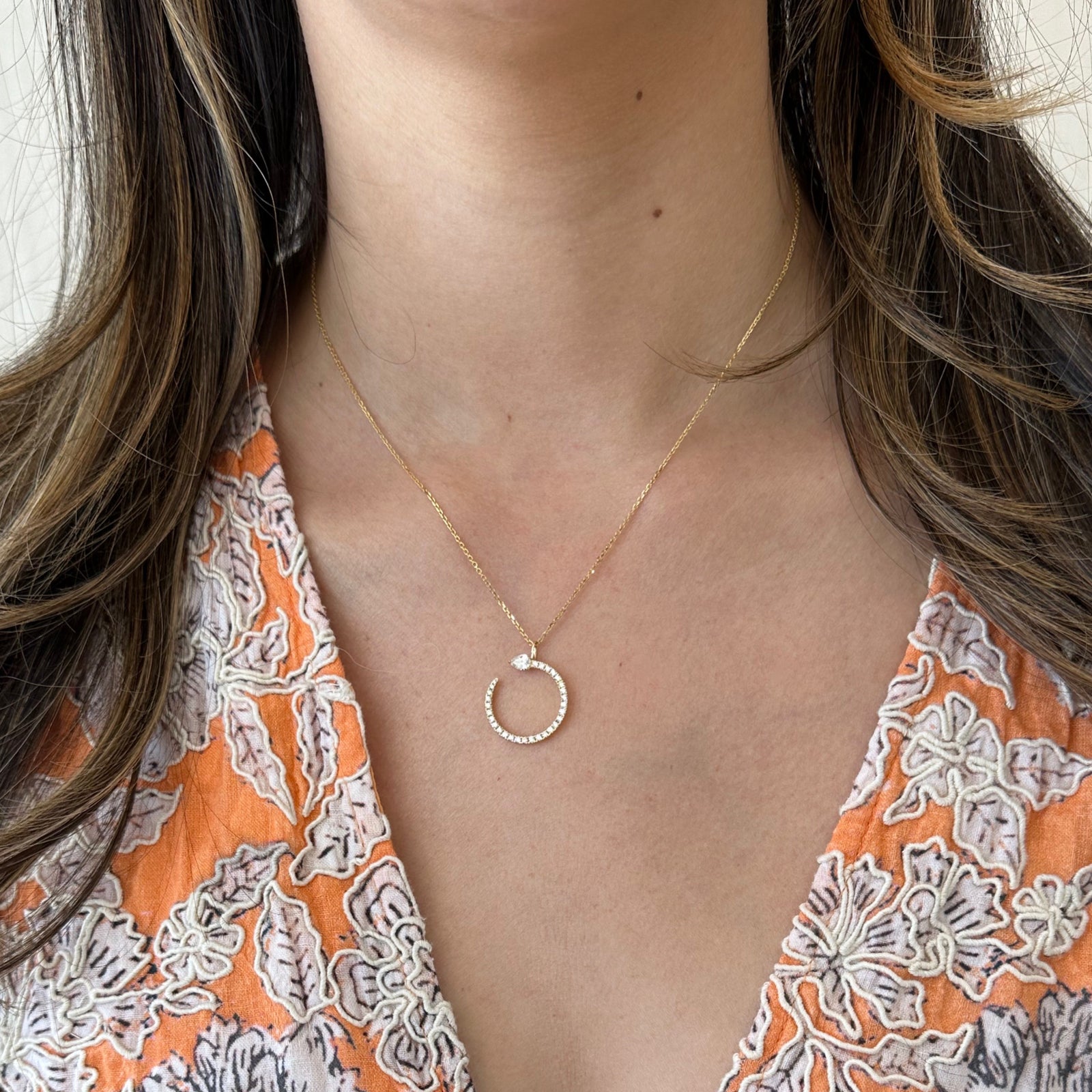 Diamond Open Circle Pendant Necklace with Pear-Shaped Diamond  -14K gold weighing 3.20 grams  - 29 round diamonds totaling 0.33  - 1 Pear diamond totaling 0.22