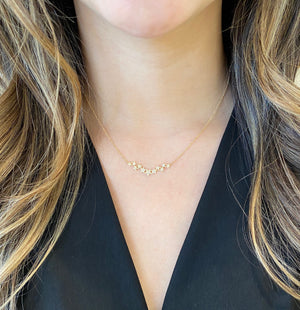 Female Model Wearing Diamond Star Bar Necklace - 14K gold weighing 1.98 grams - 79 round diamonds weighing 0.20 carats
