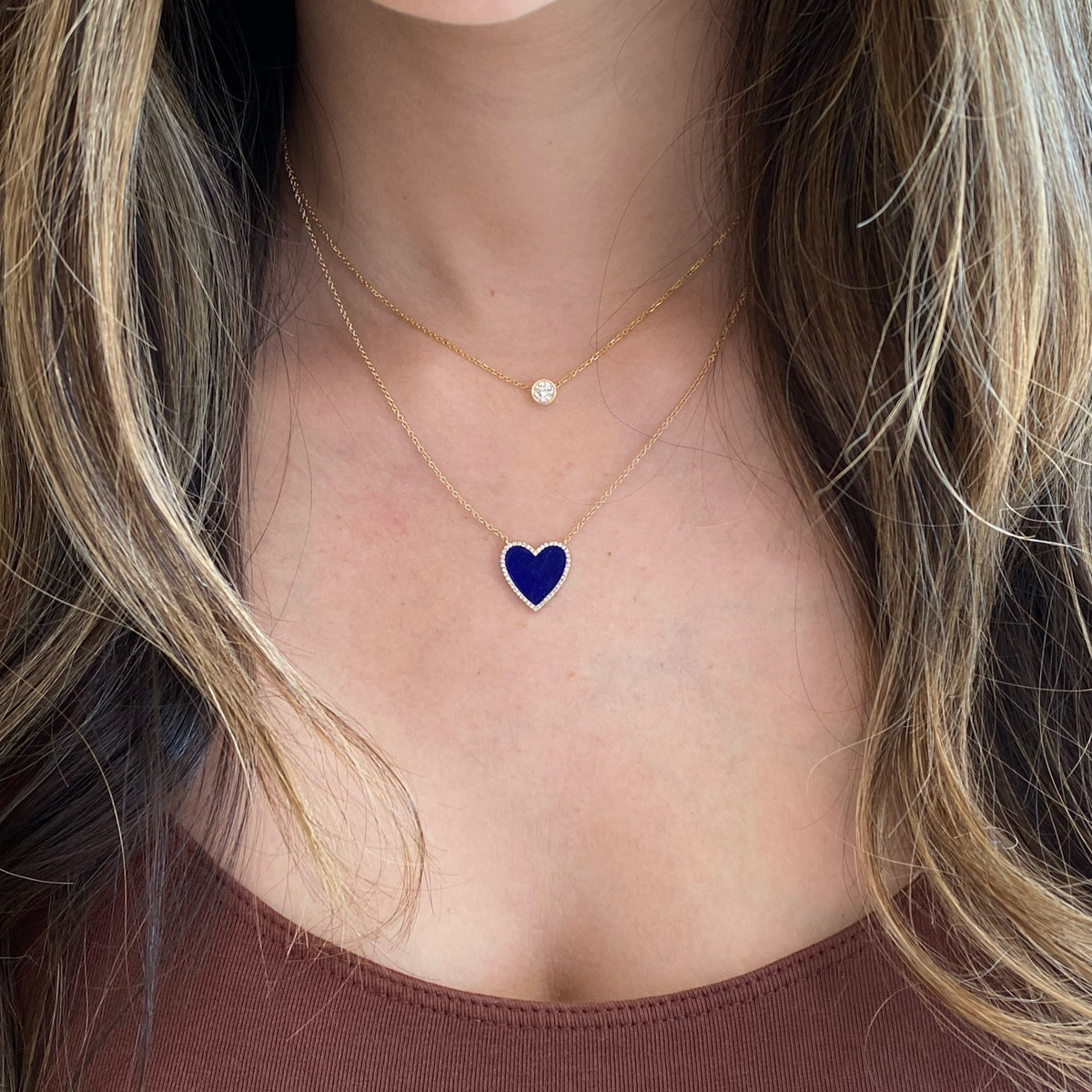 Female model wearing Lapis & Diamond Heart Necklace -14K gold weighing 2.45 grams -46 round pave-set diamonds 0.13 carats -1.83 carat lapis