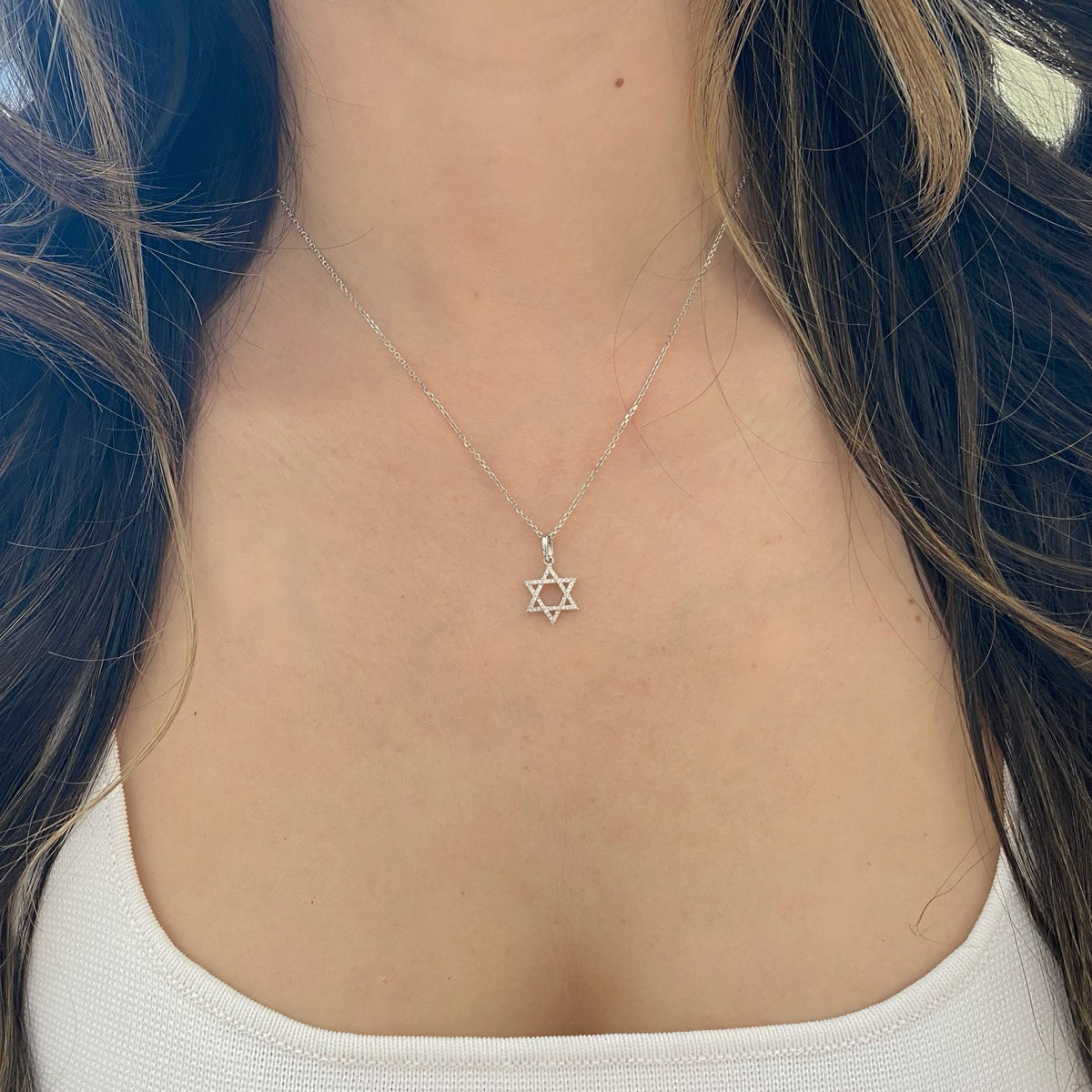 Female Model Wearing 0.10 ct Diamond Star of David Pendant - 18K gold weighing 0.97 grams - 14K gold weighing 1.60 grams - 54 round diamonds weighing 0.10 carats