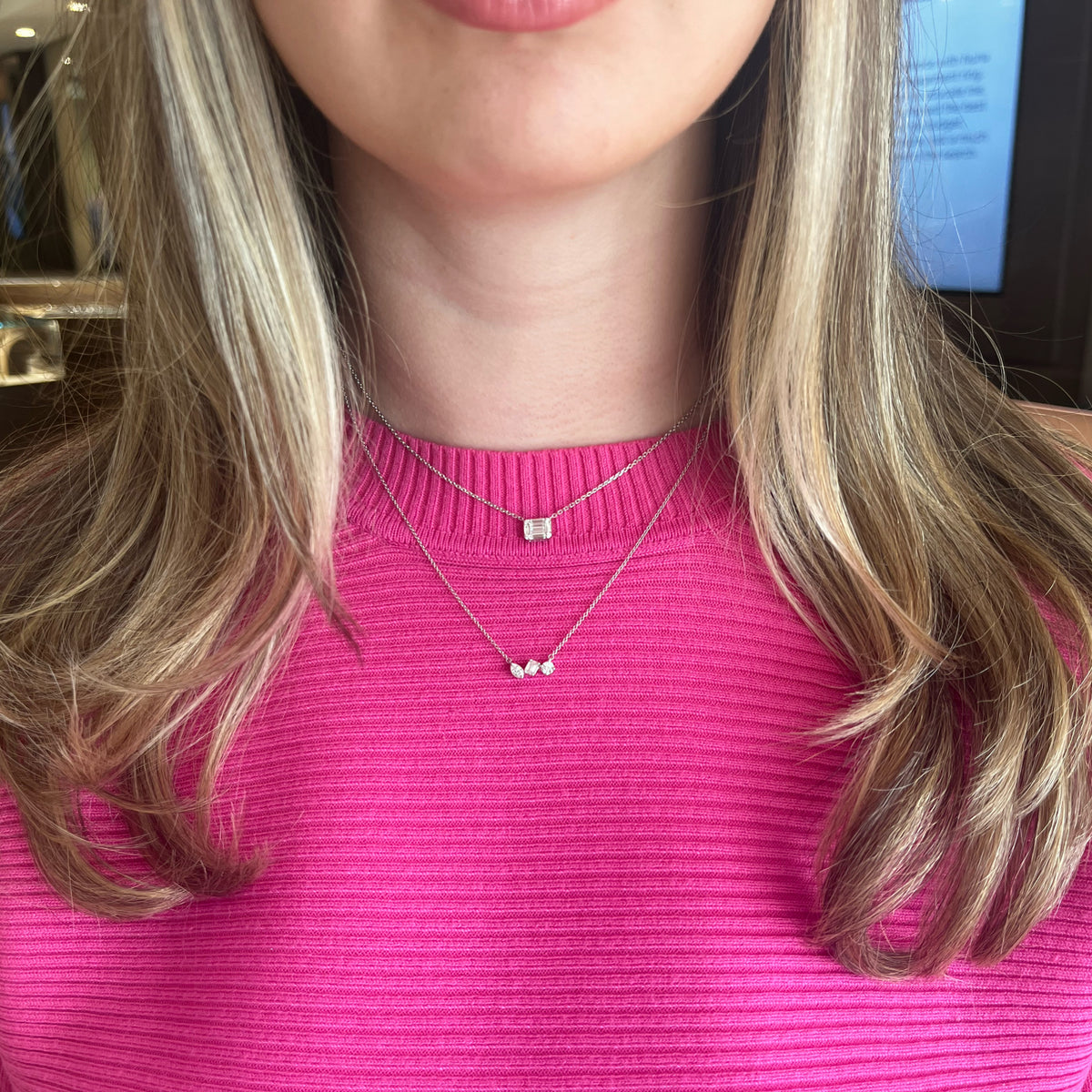 Female Model Wearing Mixed Shape Diamond Bar Pendant Necklace - 14K gold weighing 2.29 grams - 0.20 ct emerald-cut diamond - 0.15 ct marquise-shaped diamond - 0.20 ct round brilliant-cut diamond