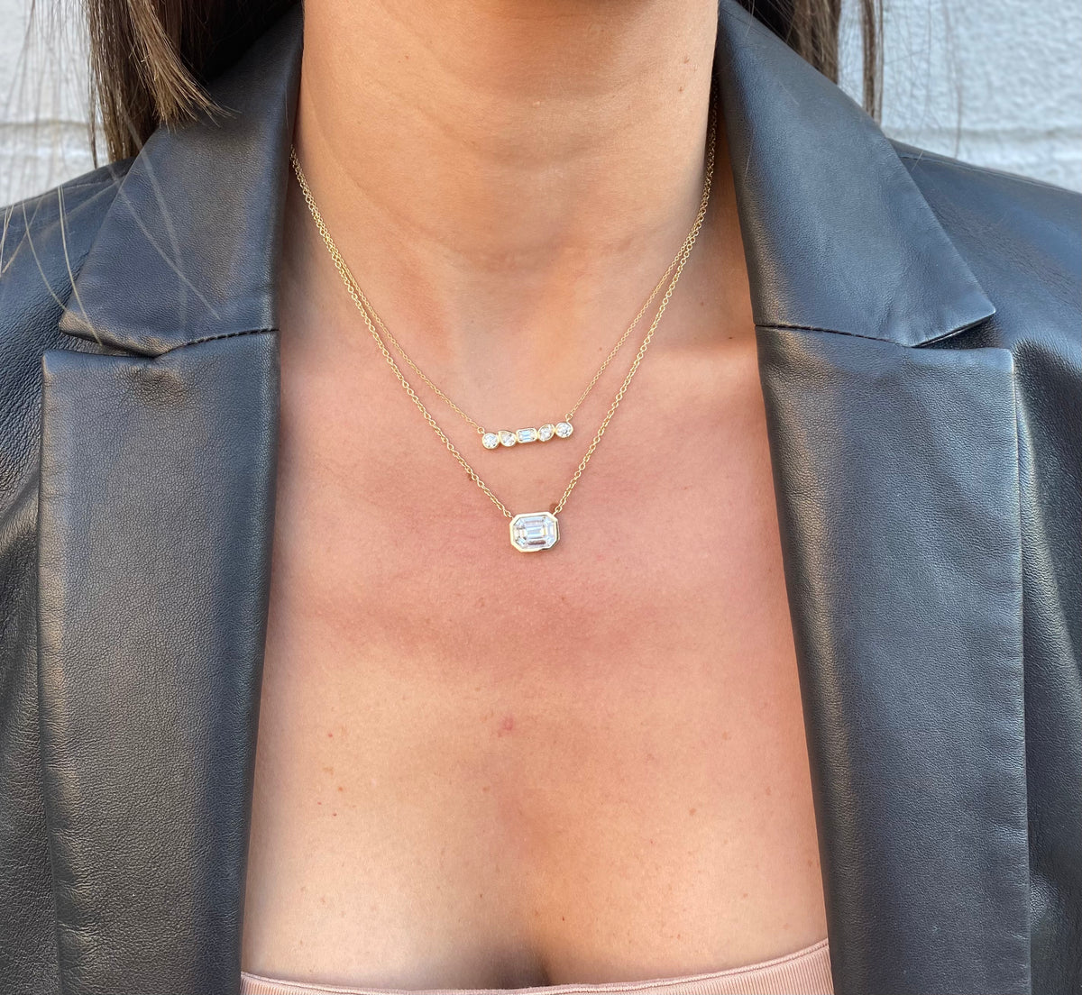 Female model wearing Bezel-Set Illusion Emerald-Cut Diamond Pendant Necklace - 14K gold weighing 4.38 grams
- 9 mixed shape diamonds weighing 1.02 carats