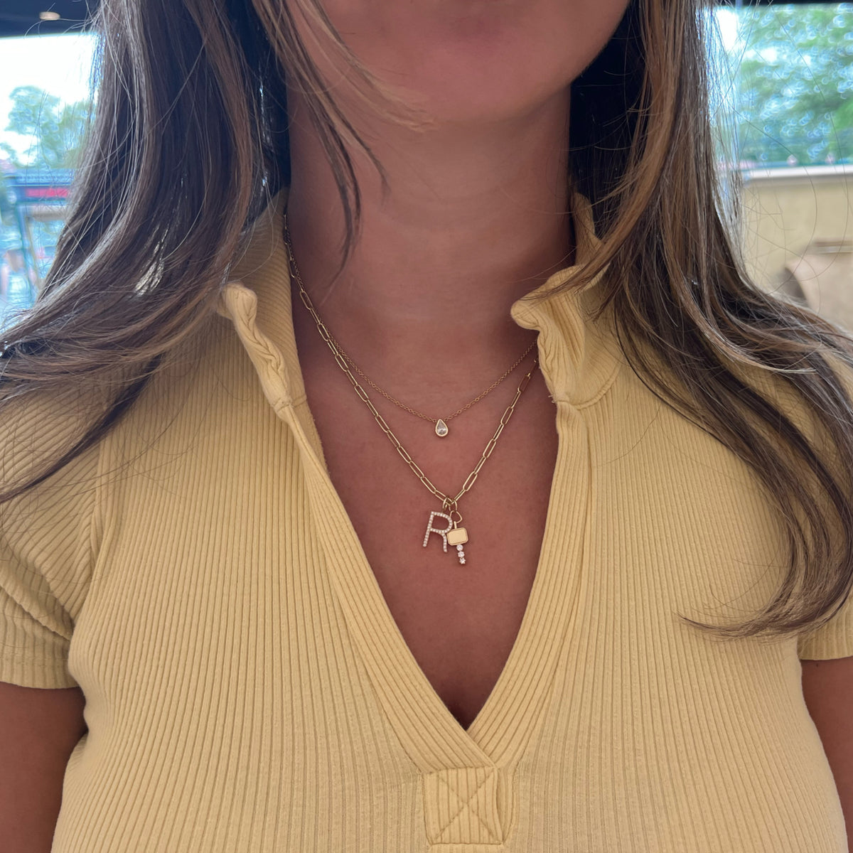 Female Model Wearing 0.33 ct Pear-Shaped Bezel-Set Diamond Pendant - 14K gold weighing 2.25 grams - 0.33 ct pear-shaped diamond