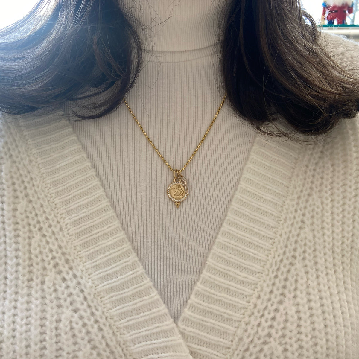 Female Model Wearing Diamond Angle Medallion Pendant - 14K gold weighing 2.78 grams - 30 round diamonds weighing 0.24 carats