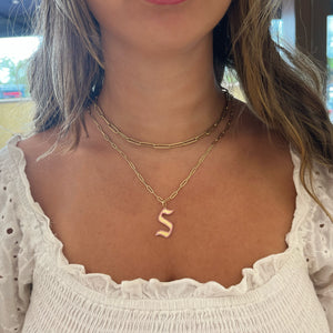 Female Model Wearing Pink Sapphire Gothic Initial Pendant - 14K gold weighing 2.45 grams - 101 pink sapphires weighing 0.35 carats