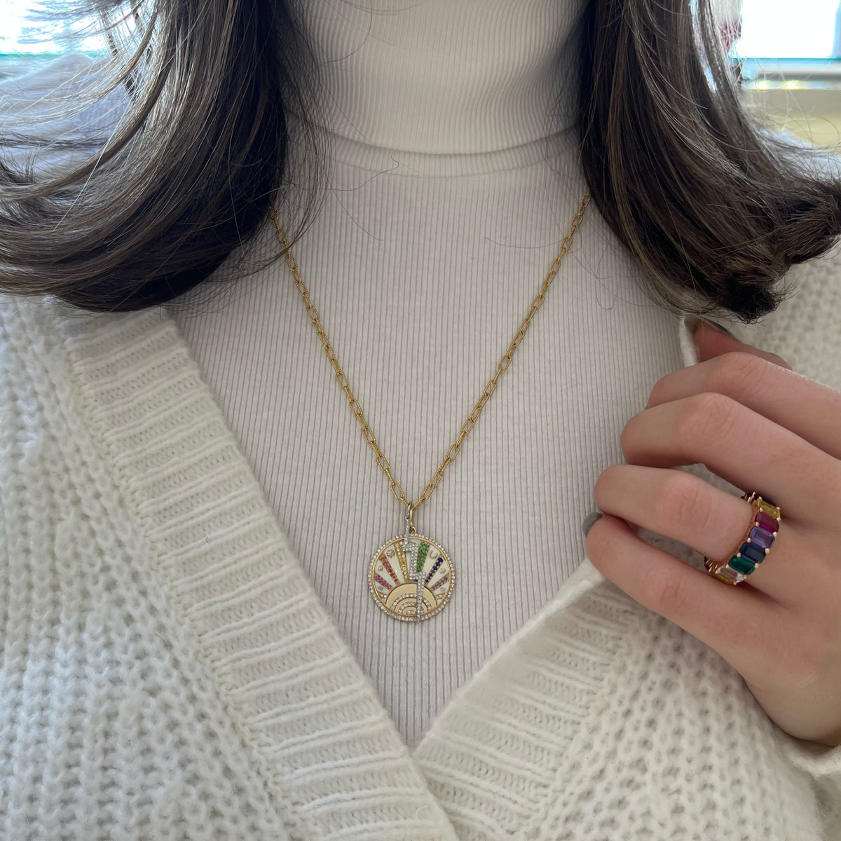 Female Model Wearing Diamond & Multicolor Sapphire Lucky Symbols Pendant - 14K gold weighing 8.20 grams - 95 round diamonds weighing 0.44 carats - 52 fancy-color sapphires weighing 0.38 carats