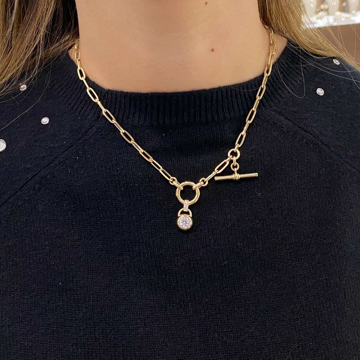 Female model wearing Diamond Bezel Pendant - 14K yellow gold weighing 21.60 grams - 0.64 ct diamond (GIA-graded H color, SI1 clarity)