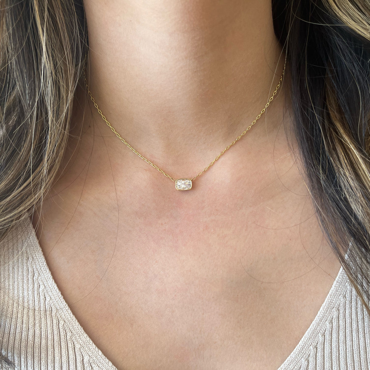 Female Model Wearing 1.05 ct Cushion-Cut Diamond Solitaire Pendant Necklace - 14K gold weighing 2.83 grams - 1.05 ct cushion-shaped diamond (GIA-graded F color, VS2 clarity)