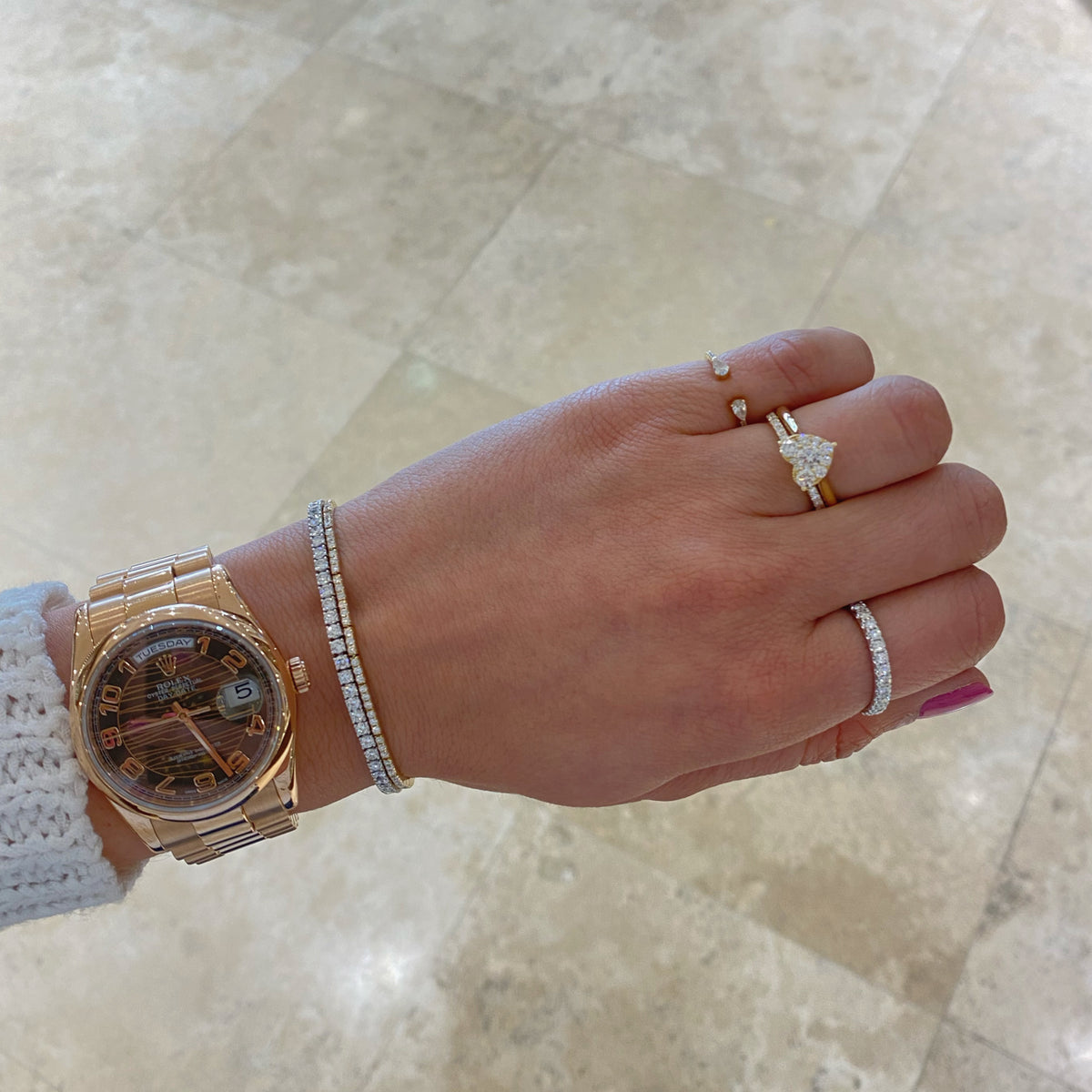 Female Model Wearing Diamond Heart Engagement Ring - 18K gold weighing 3.14 grams  - 10 round diamonds weighing 0.60 carats