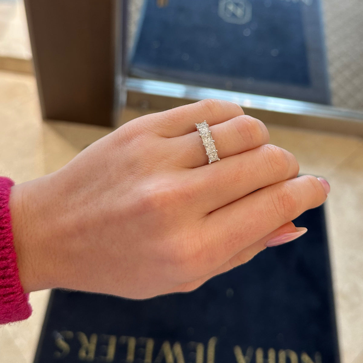 Female model wearing Princess-Cut Diamond Ring -18k gold weighing 4.20 grams -5 princess-cut four prong-set diamonds weighing 2.42 carats with G-H VS2-SI1