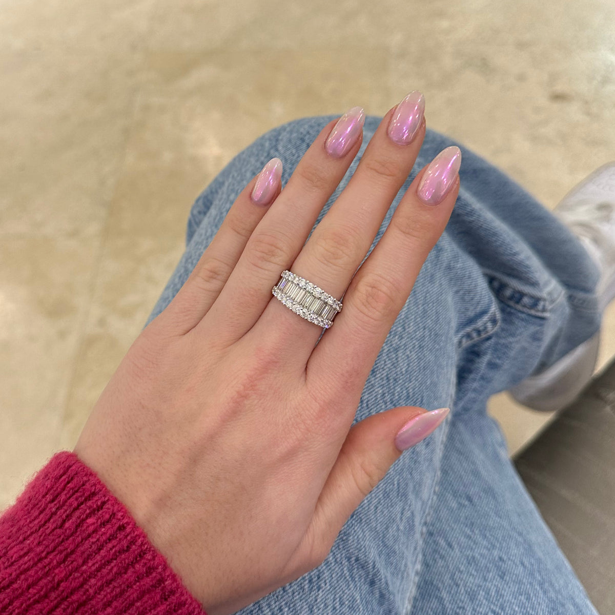 Female model wearing Baguette & Round Diamond Wedding Band -18K gold weighing 9.73 grams -15 slim baguettes totaling 1.52 carats -24 round diamonds totaling 1.31 carats