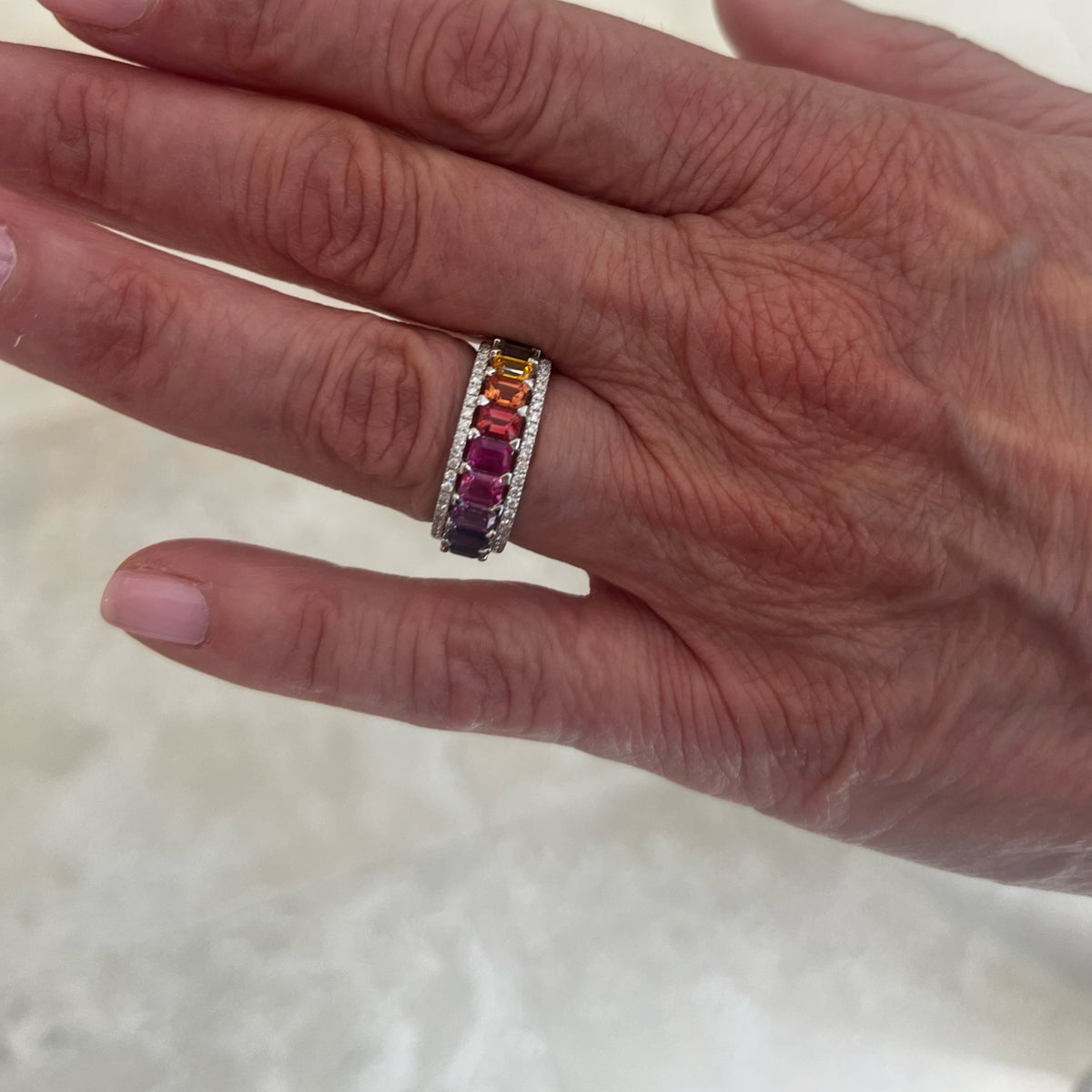 Rainbow Emerald-Cut Sapphire Ring - 18K gold weighing 7.93 grams - 10 emerald-cut sapphires weighing 2.60 carats - 48 round diamonds weighing 0.26 carats