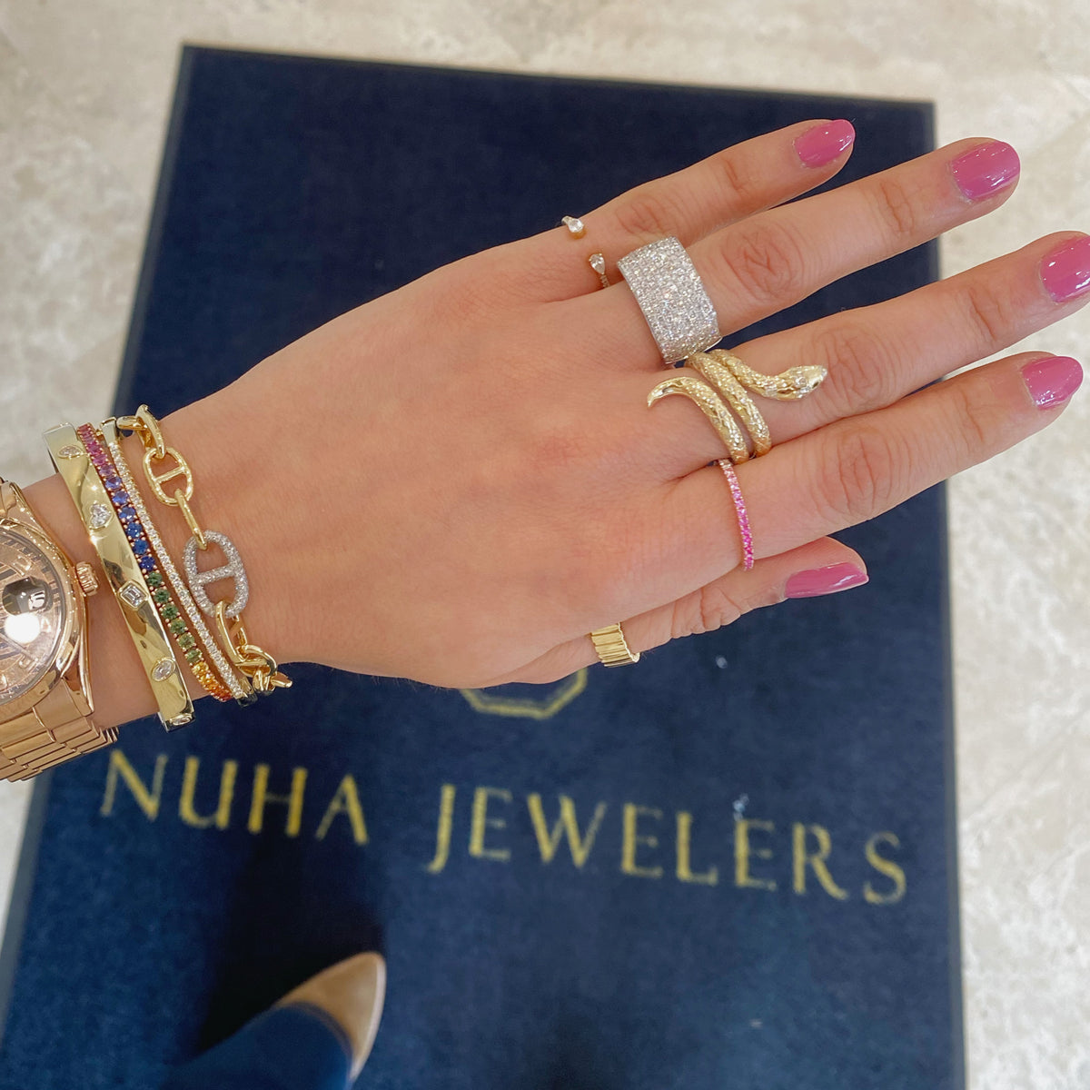 Female Model Wearing Diamond & Emerald Serpent Ring - 14K gold weighing 5.92 grams - 95 round diamonds weighing 0.28 carats - 2 emeralds weighing 0.01 carats