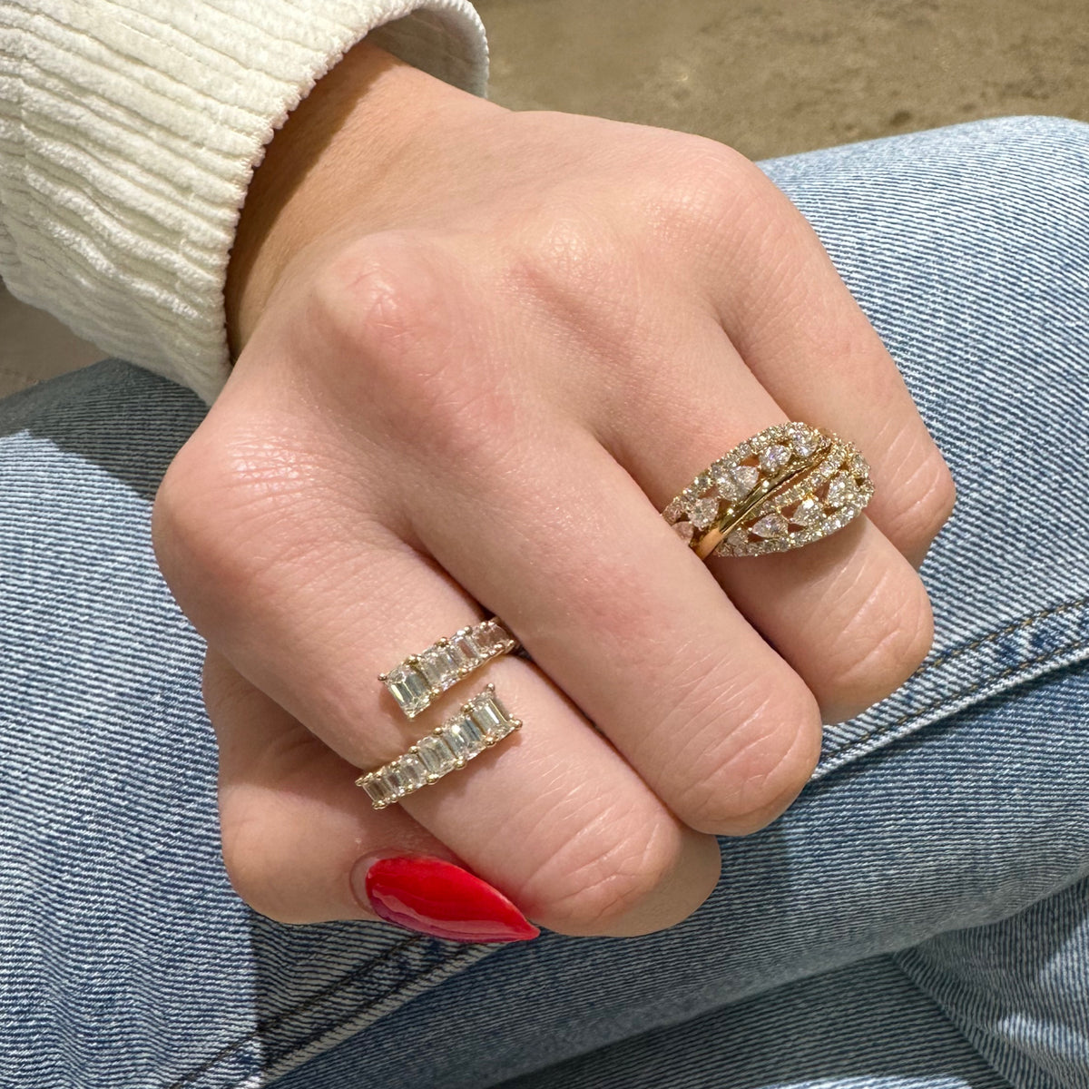 Female model wearing Round & pear-shaped diamond crossover ring - 18K gold weighing 6.54 grams  - 14 pear-shaped diamonds weighing 1.16 carats  - 50 round diamonds weighing 0.59 carats