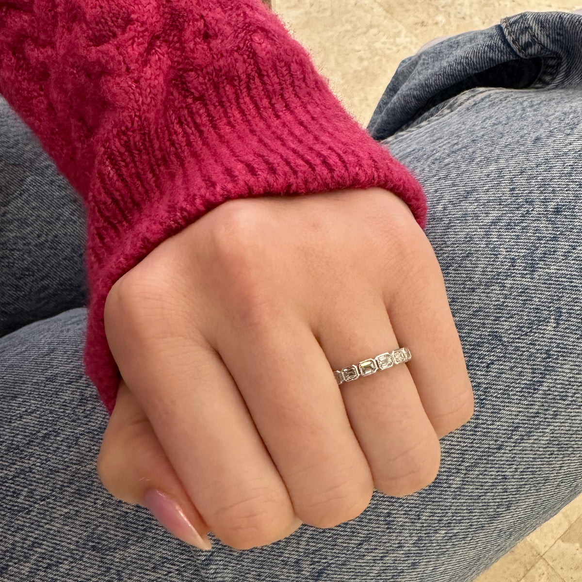 Female model wearing Bezel-Set Emerald Cut Diamond Wedding Band - 18K gold weighing 2.55 grams - 7 emerald-cut diamonds weighing 0.63 carats