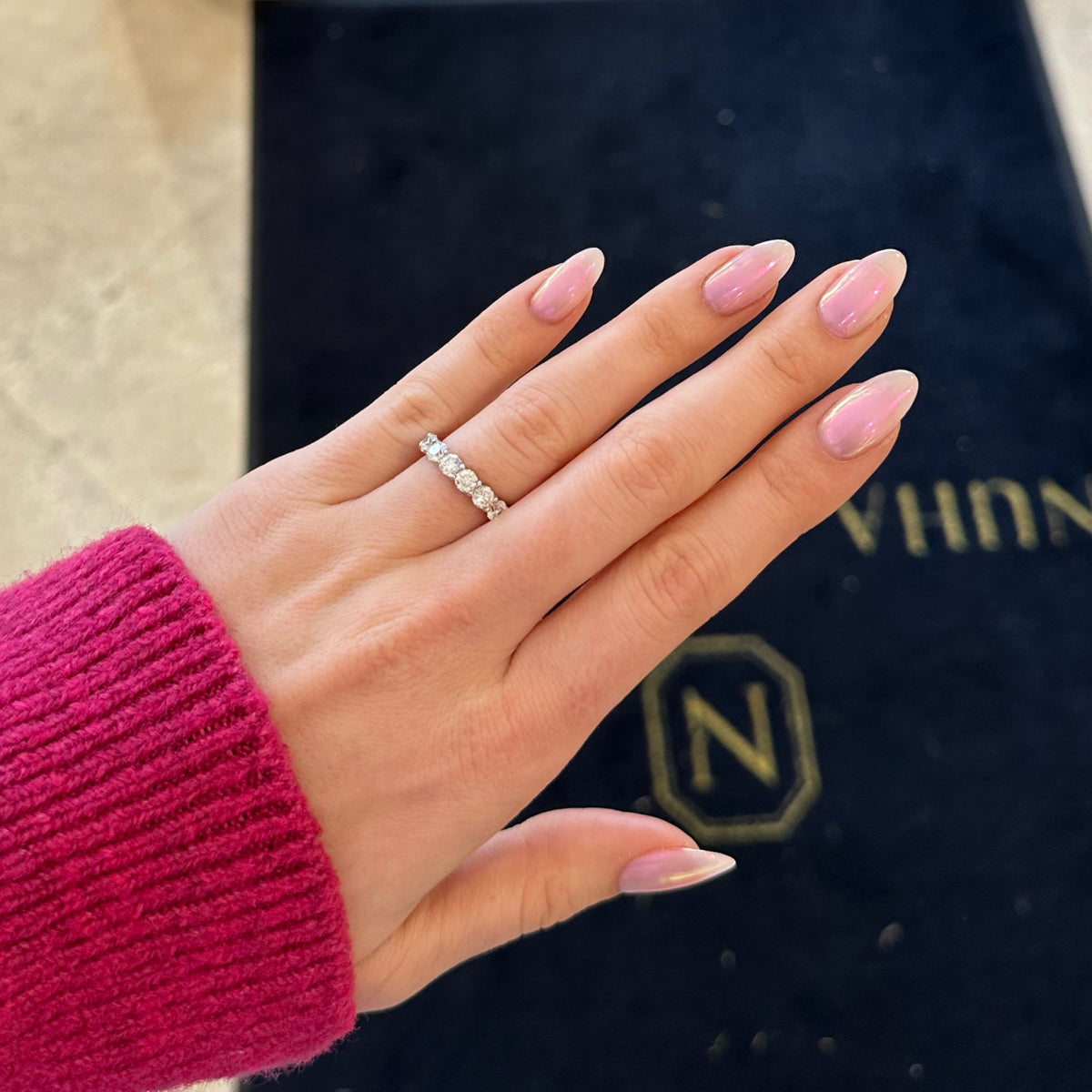 Female model wearing 3.76 ct Diamond Eternity Ring - 18K gold weighing 3.60 grams - 16 round diamonds weighing 3.76 carats (GIA-graded G-H color, SI1 clarity)