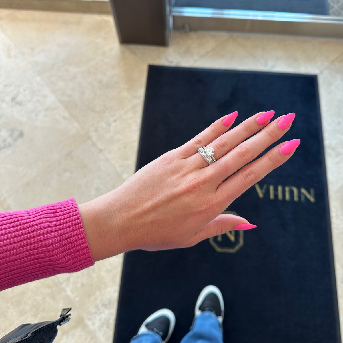 Female Model Wearing Round & baguette diamond pattern ring - 18K gold weighing 4.45 grams - 50 round diamonds weighing 0.45 carats - 10 straight baguettes weighing 0.43 carats