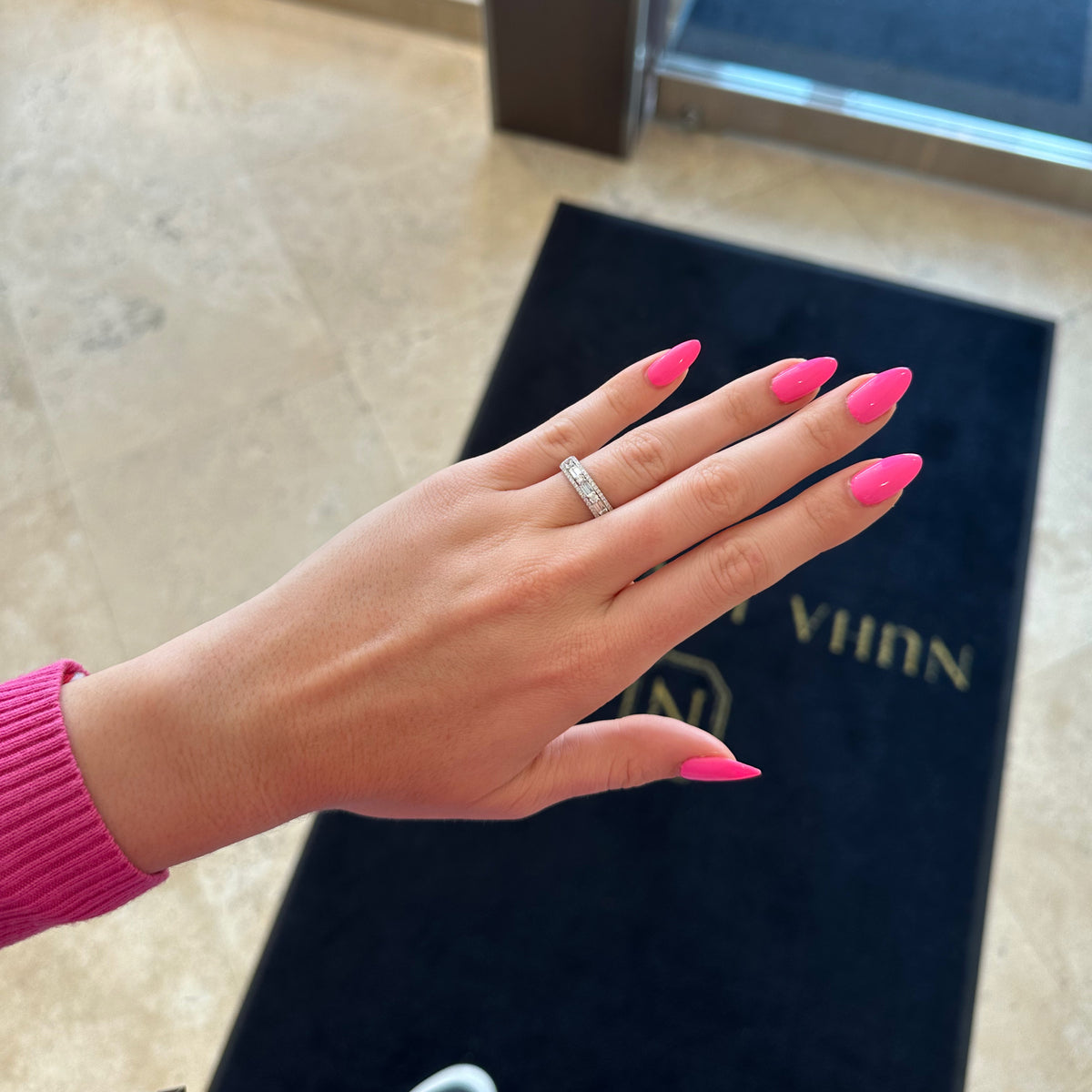 Female Model Wearing Round & baguette diamond pattern ring - 18K gold weighing 4.45 grams - 50 round diamonds weighing 0.45 carats - 10 straight baguettes weighing 0.43 carats