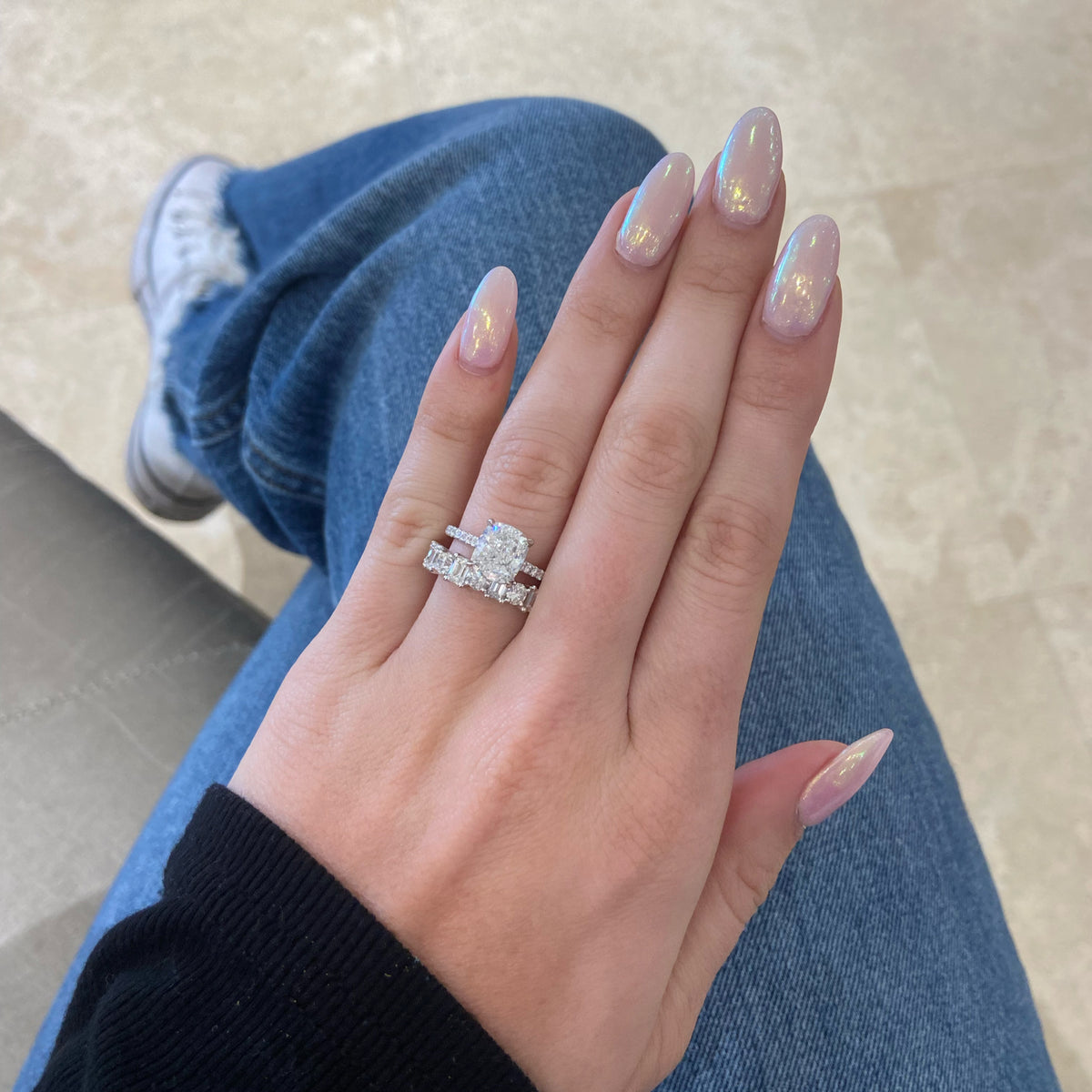 Female Model Wearing Emerald-Cut & Round Diamond Wedding Band - 18K gold weighing 3.53 grams - 4 round diamonds weighing 0.74 carats - 5 emerald-cut diamonds weighing 0.97 carats