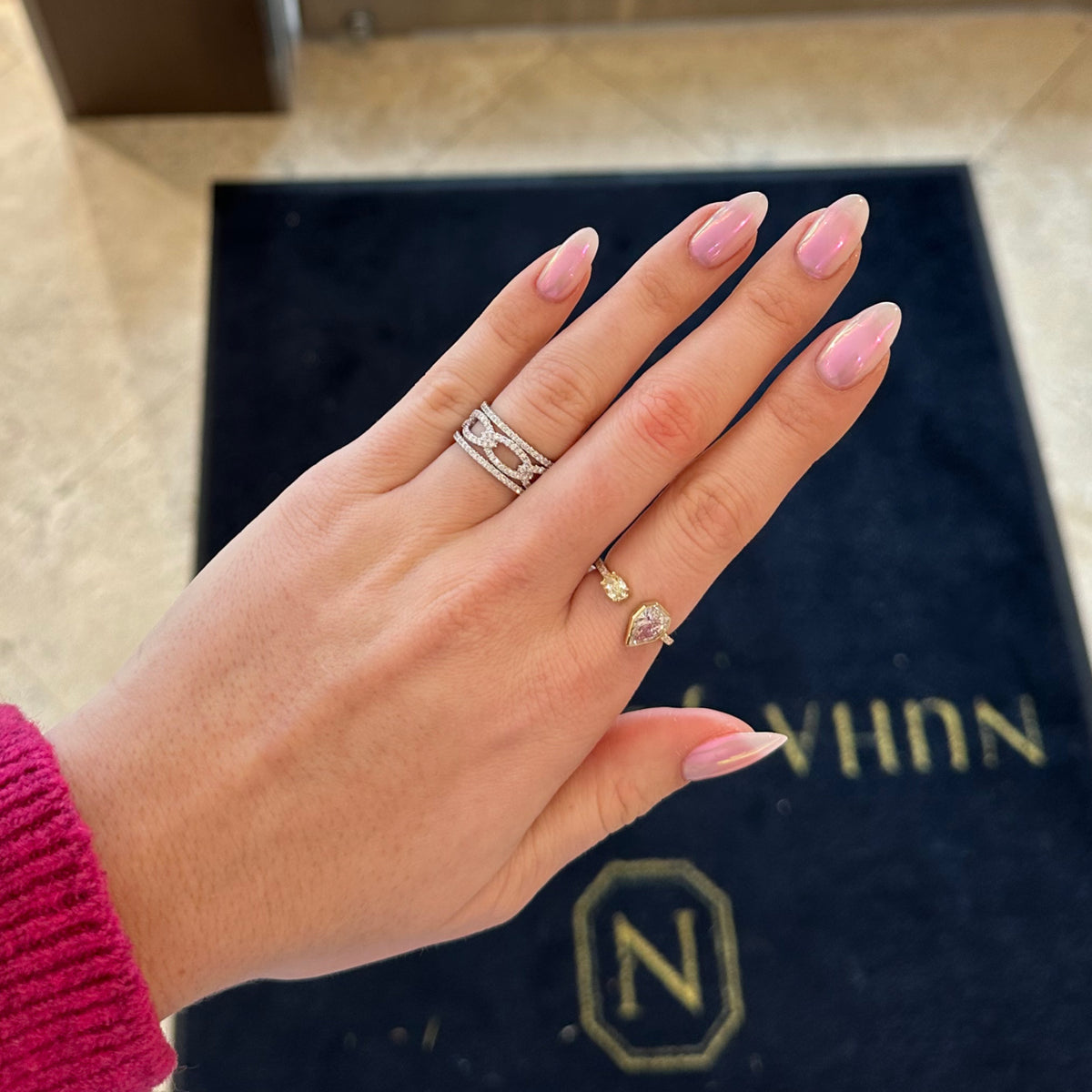 Female Model Wearing Diamond Heptagon & Yellow Diamond Oval Open Ring - 14K gold weighing 2.58 grams - 0.46 ct Fancy yellow, oval brilliant-cut diamond  - 1.04 ct pear-shaped diamond (GIA-graded D color, VS1 clarity)  - 9 round diamonds weighing 0.09 carats