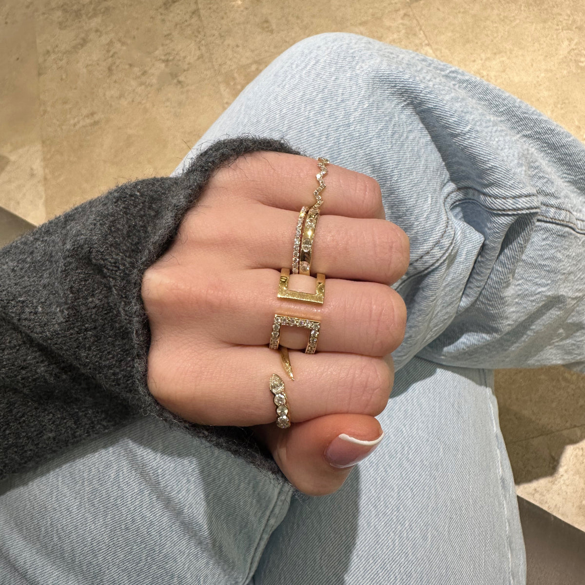 Female Model Wearing Bezel-Set Diamond Snake Ring - 14K gold weighing 2.12 grams - 4 round diamonds weighing 0.30 carats - 0.15 ct pear-shaped diamond