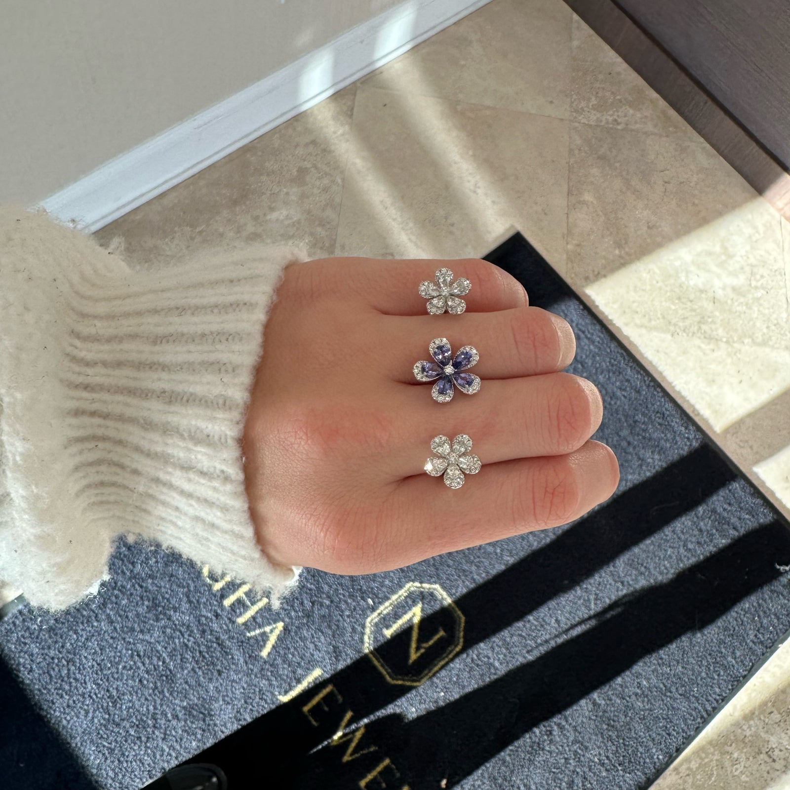 Tanzanite & Diamond Flower Two-Finger Ring - 14K gold weighing 9.20 grams   - 78 round diamonds weighing 0.54 carats  - 10 pear-shaped diamonds weighing 1.10 carats  - 5 pear-shaped tanzanites weighing 1.34 carats